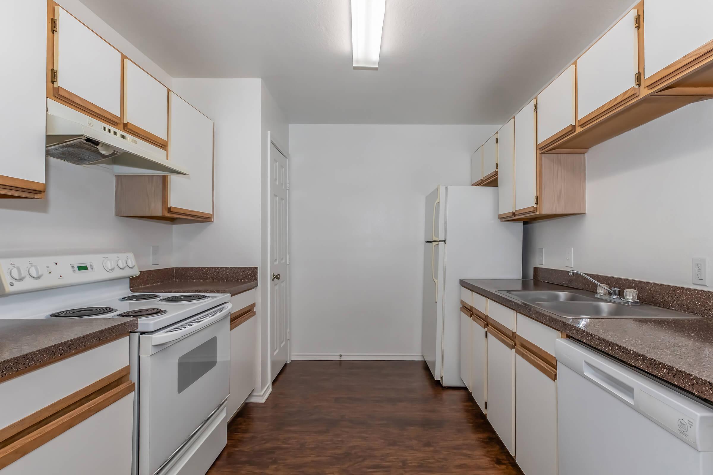 a kitchen with a stove sink and refrigerator