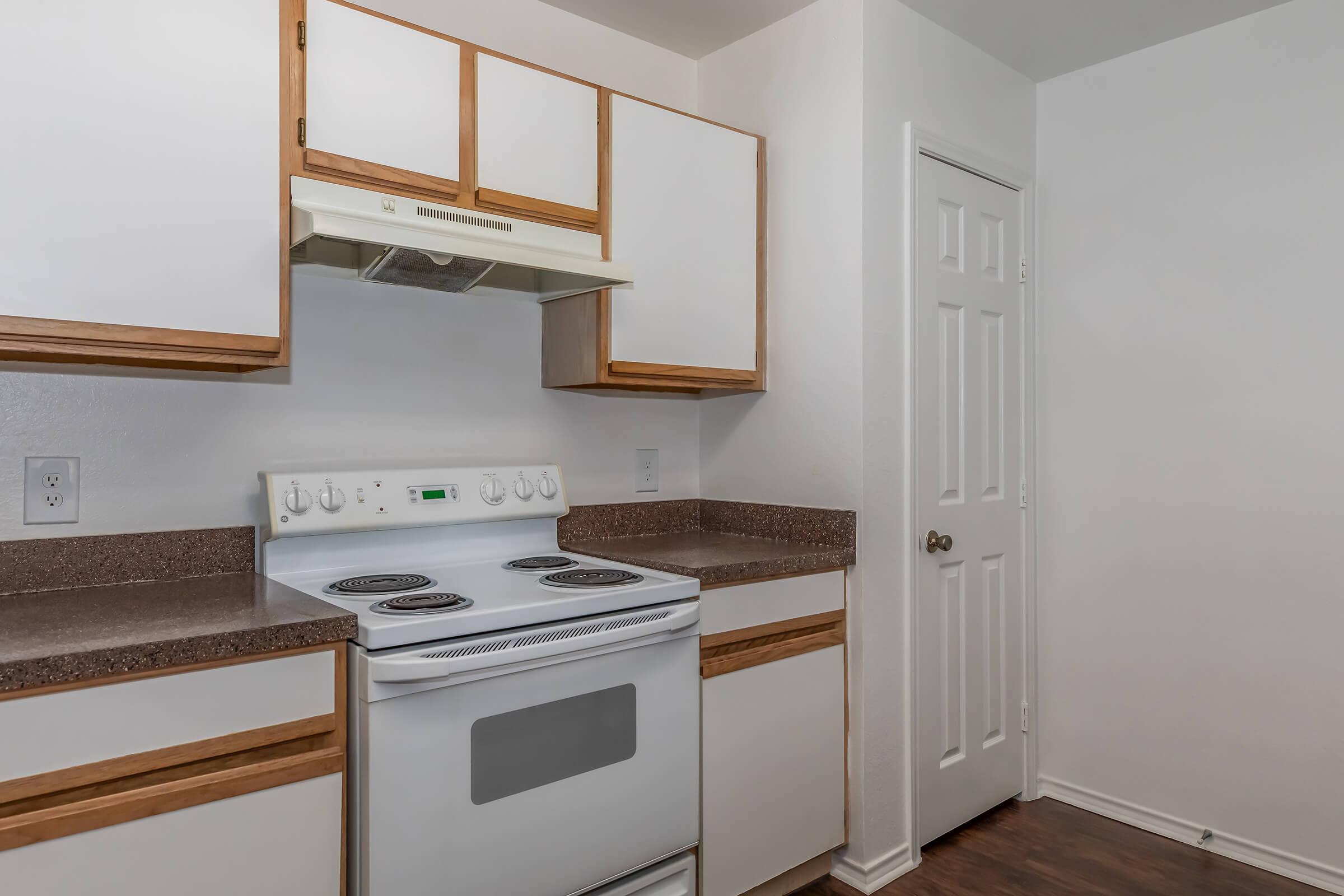 a stove top oven sitting inside of a kitchen