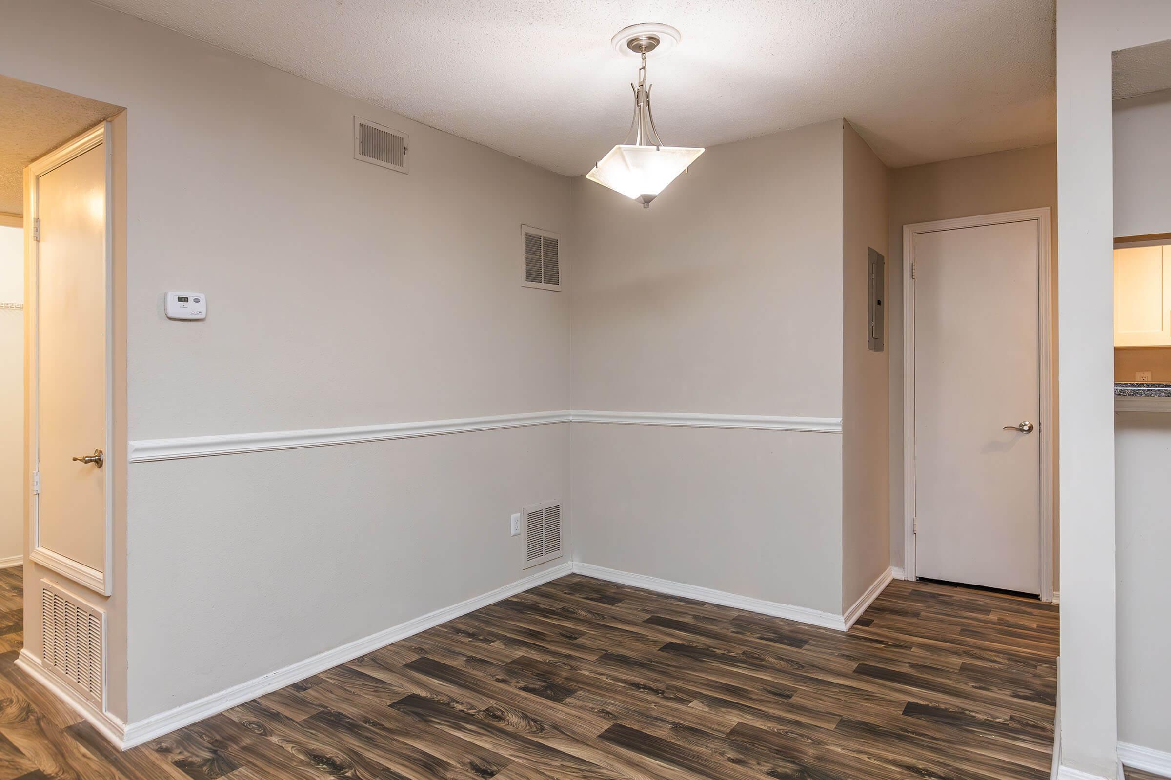 a large empty room with a sink and a mirror