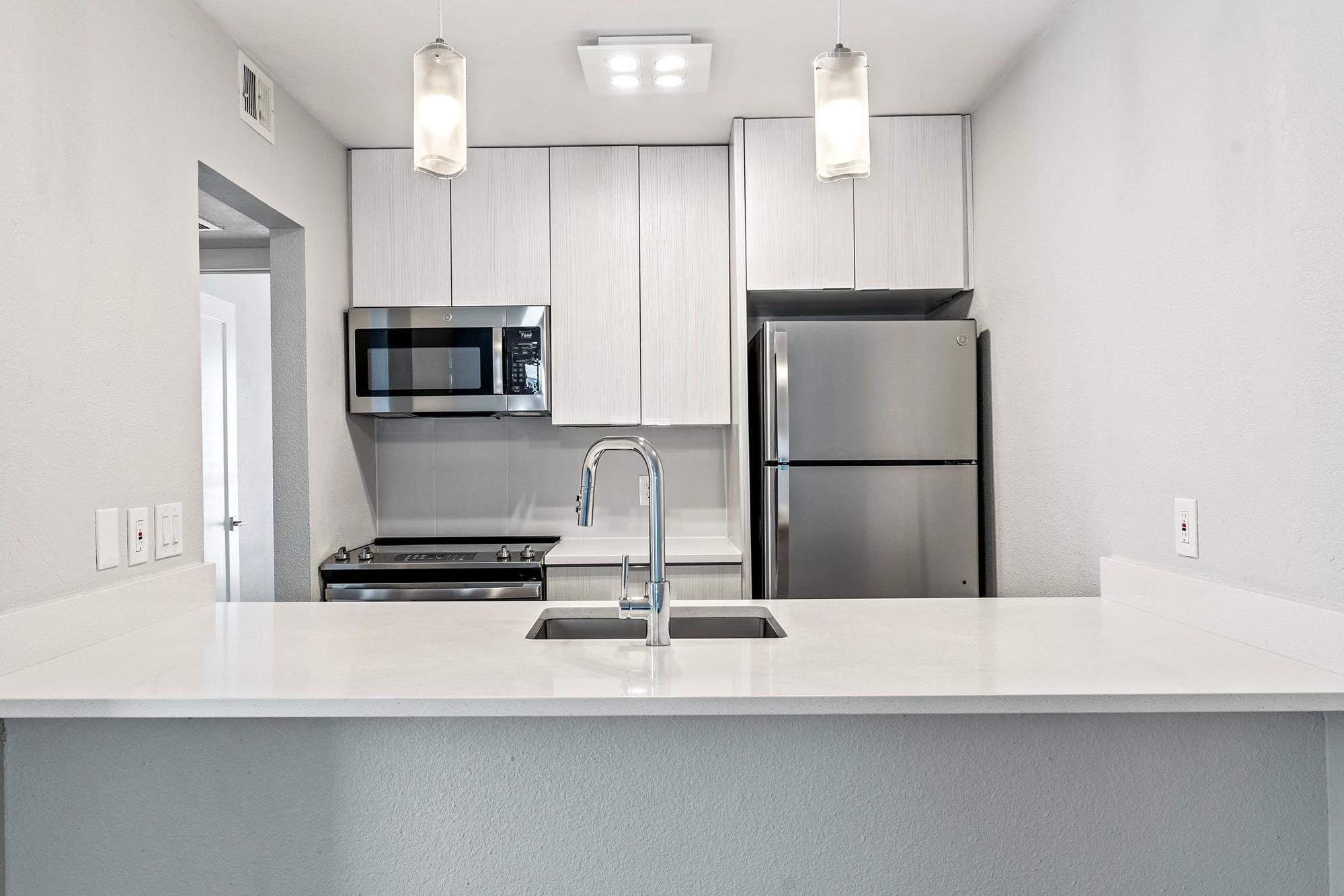 a kitchen with a sink and a mirror