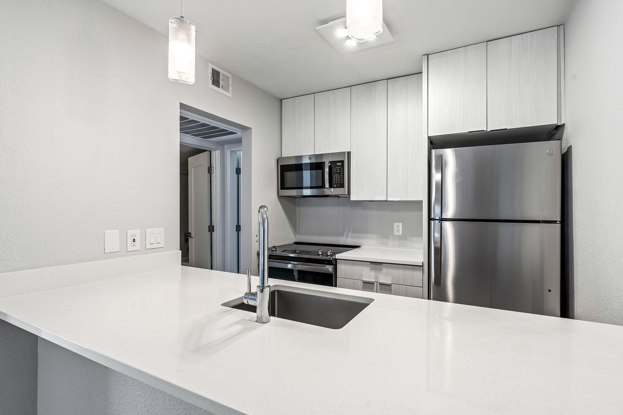 a kitchen with a sink and a refrigerator