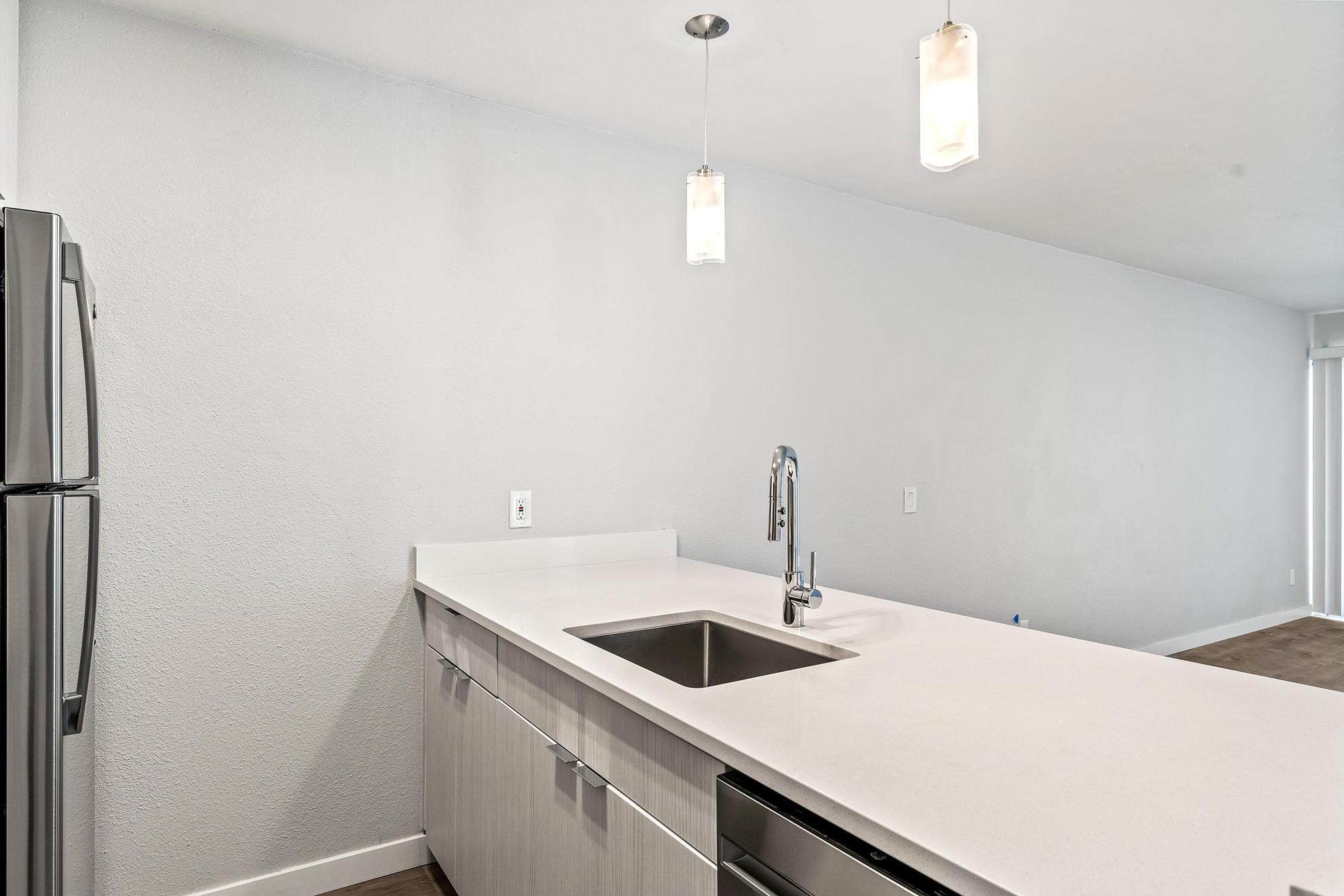 a kitchen with a sink and a mirror