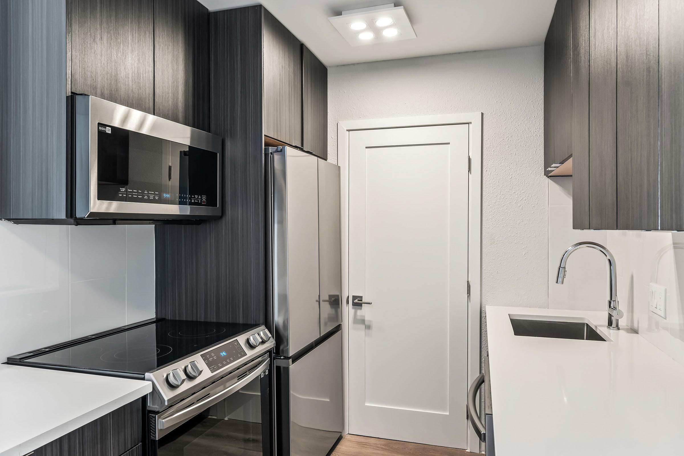 a kitchen with a sink and a mirror