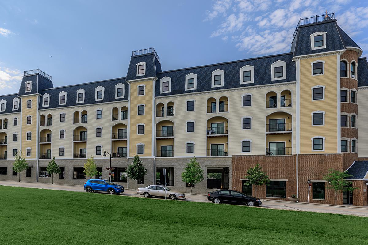 a large building with a grassy field