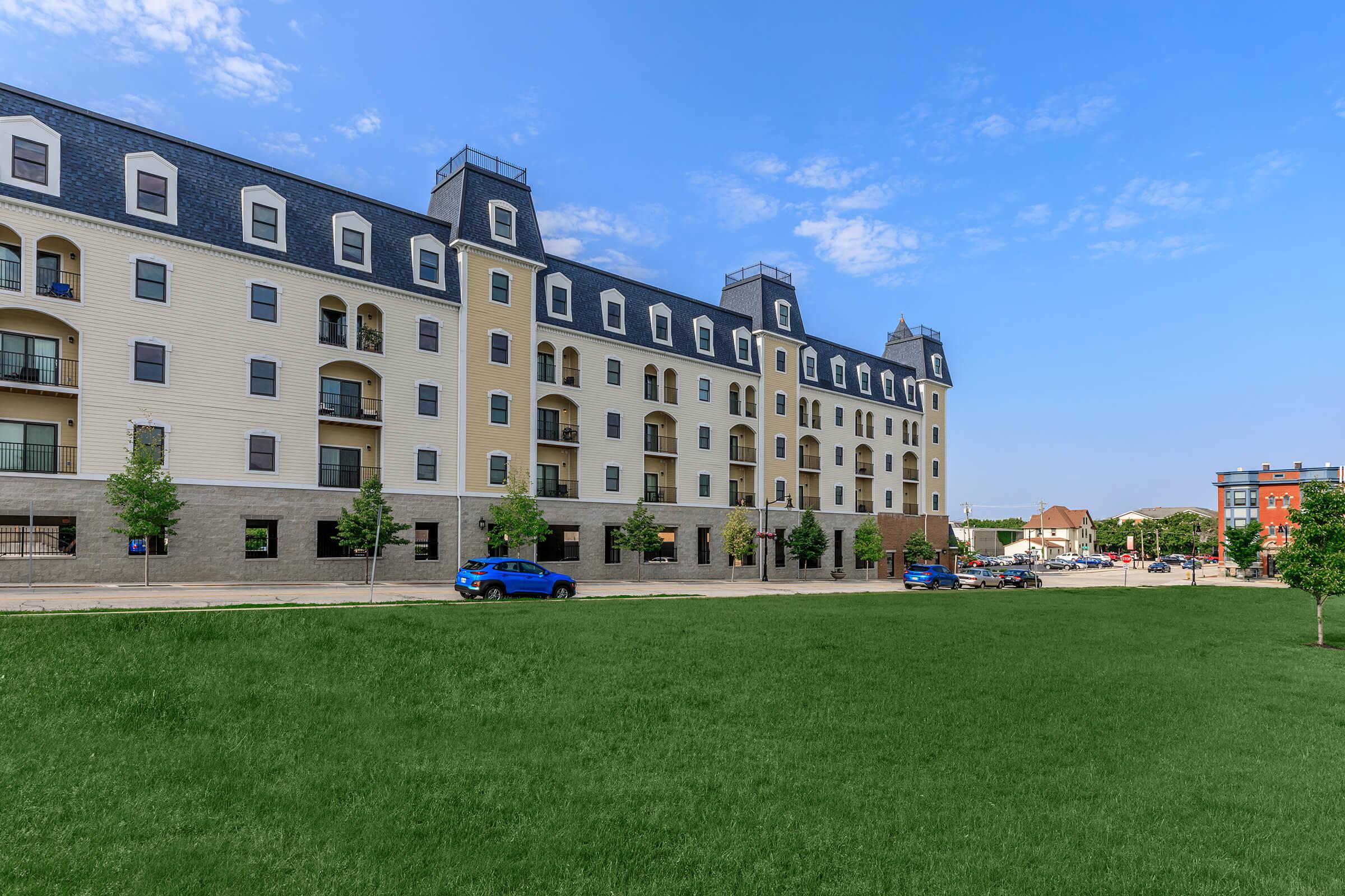 a large building with a grassy field