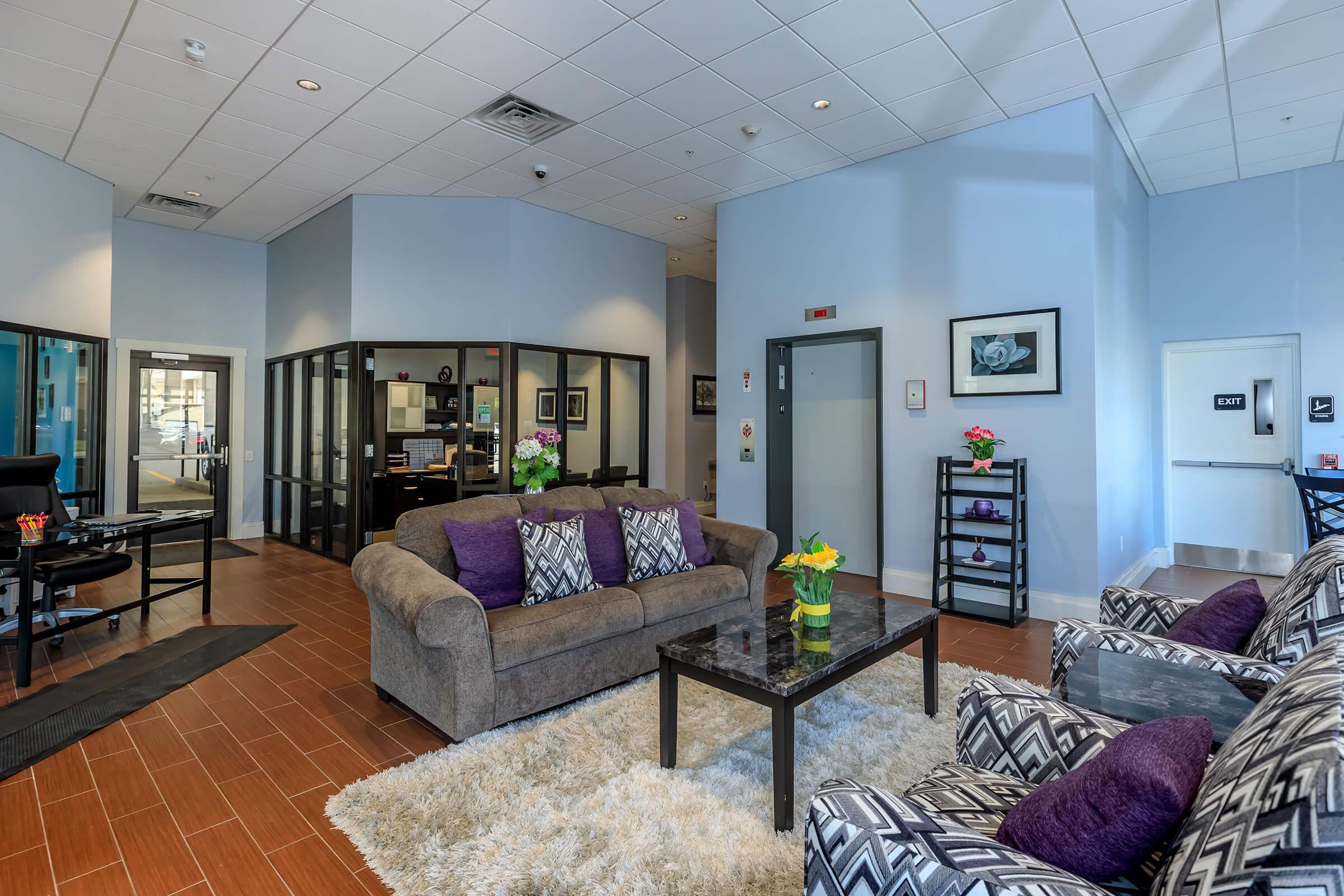 a living room filled with furniture and a flat screen tv