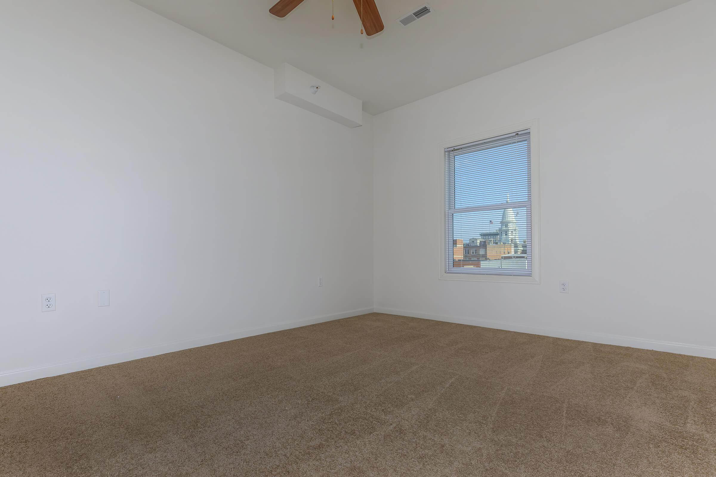 a bedroom with a large window