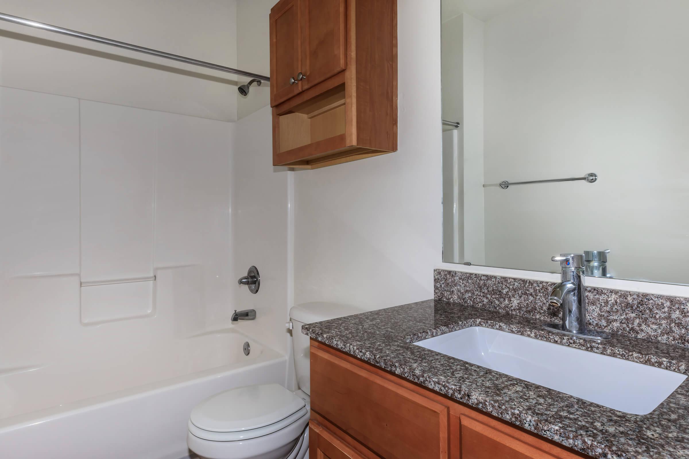 a kitchen with a sink and a mirror