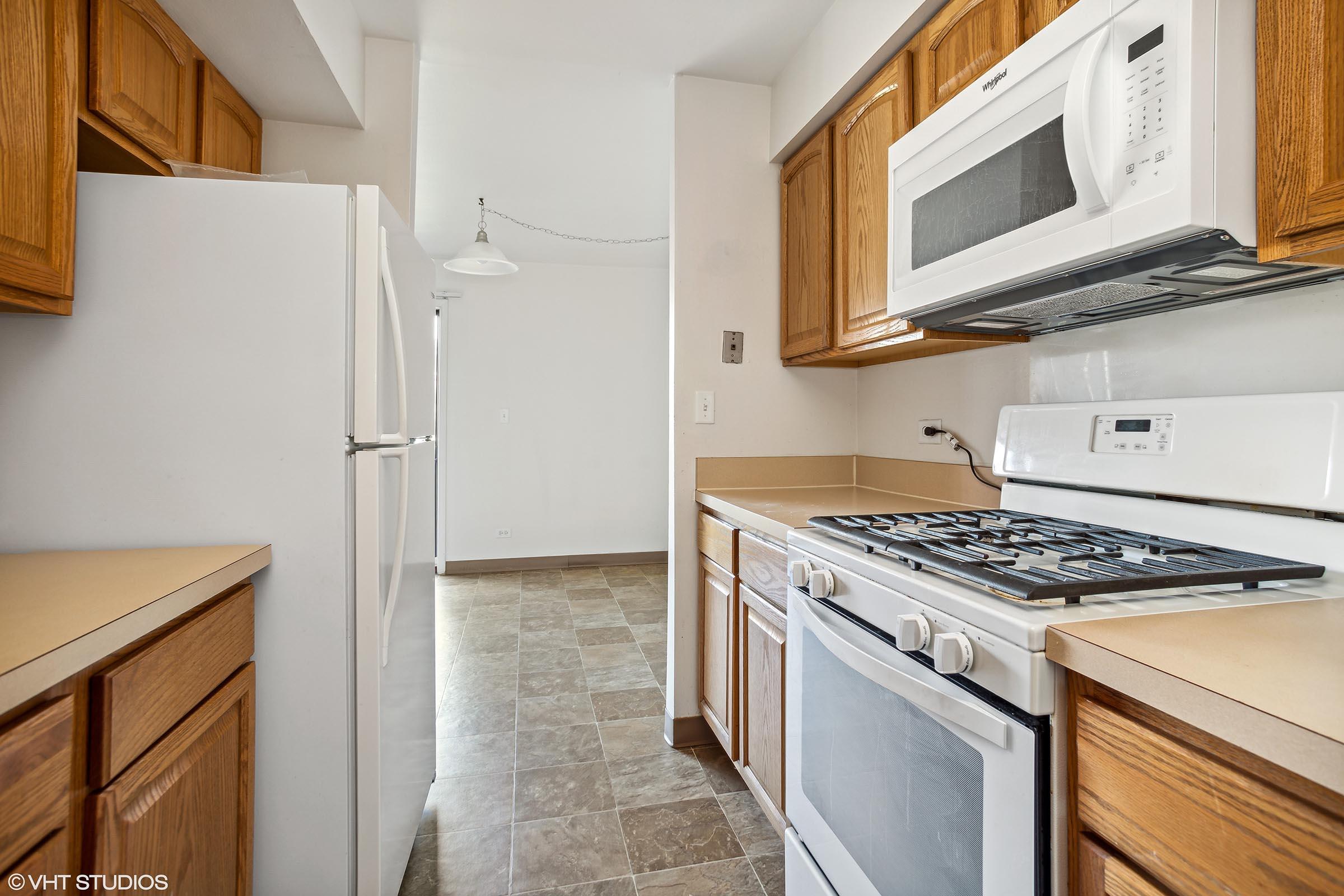 a kitchen with a stove top oven sitting inside of a refrigerator