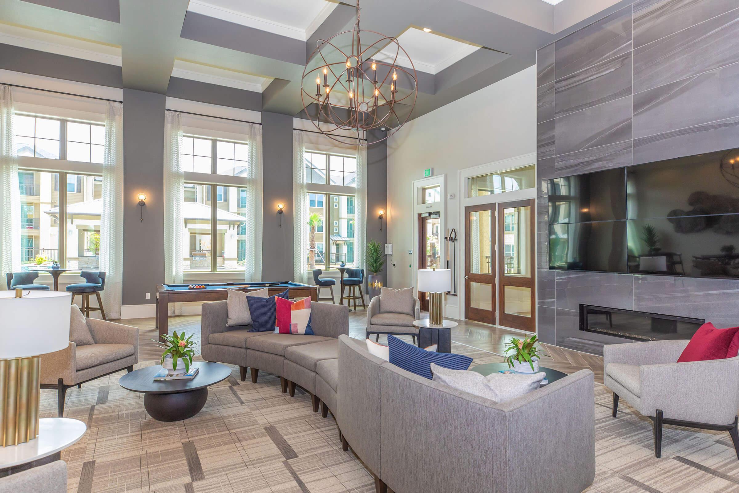 a living room filled with furniture and a large window