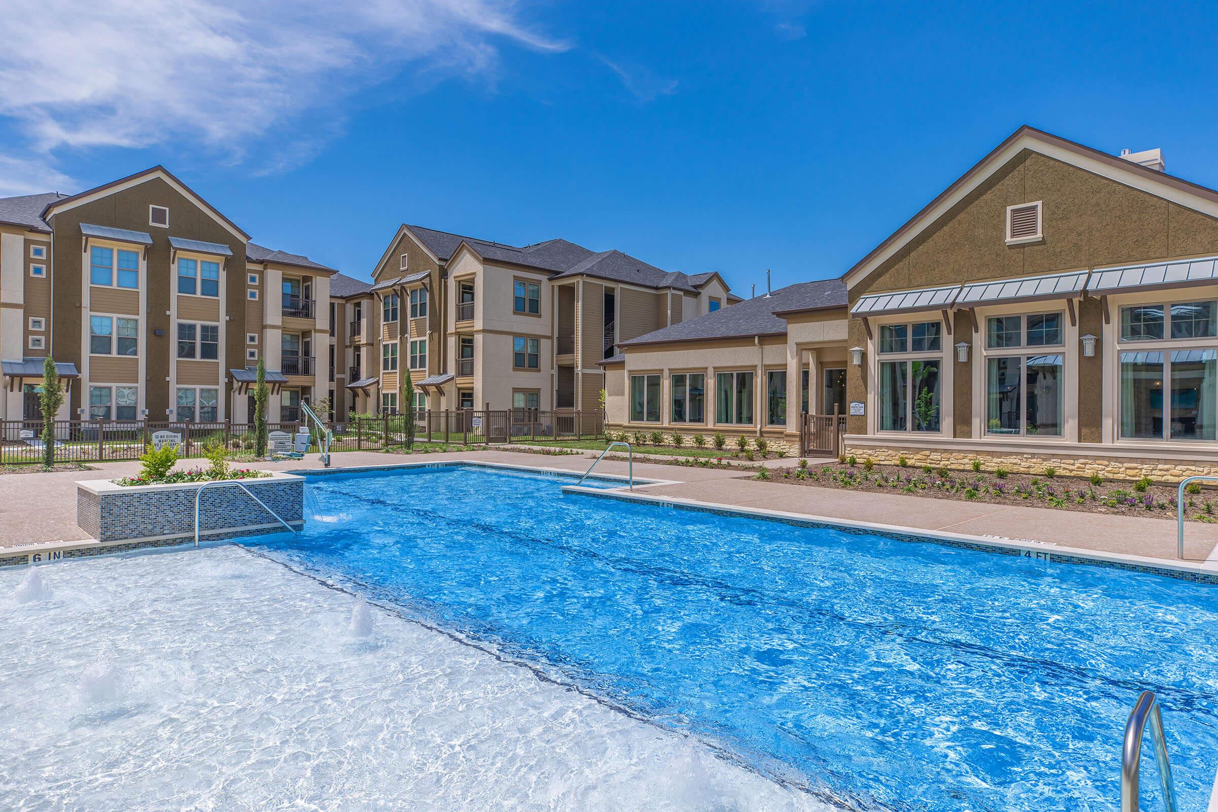 a house with a pool in front of a building