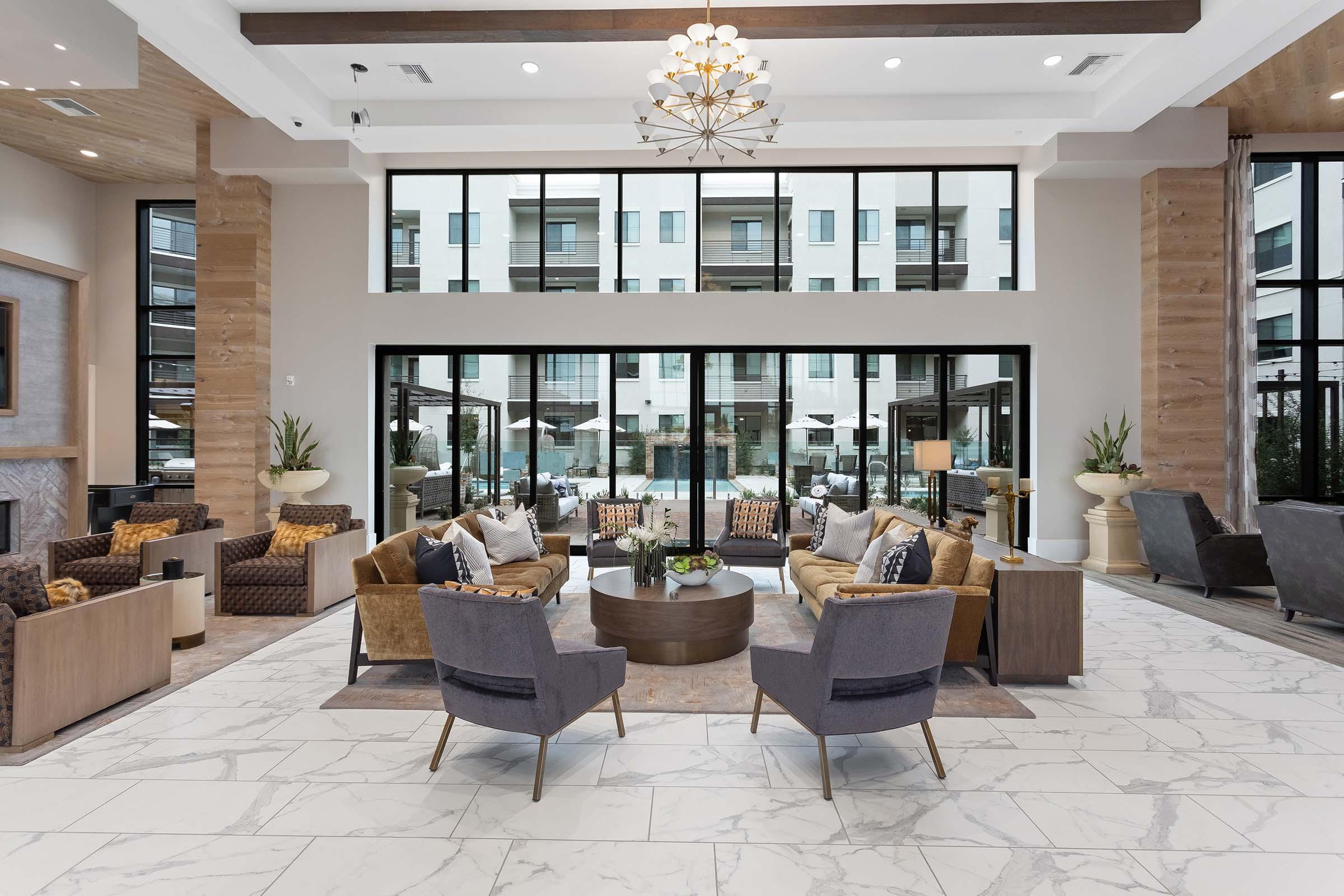 a living room filled with furniture and a large window