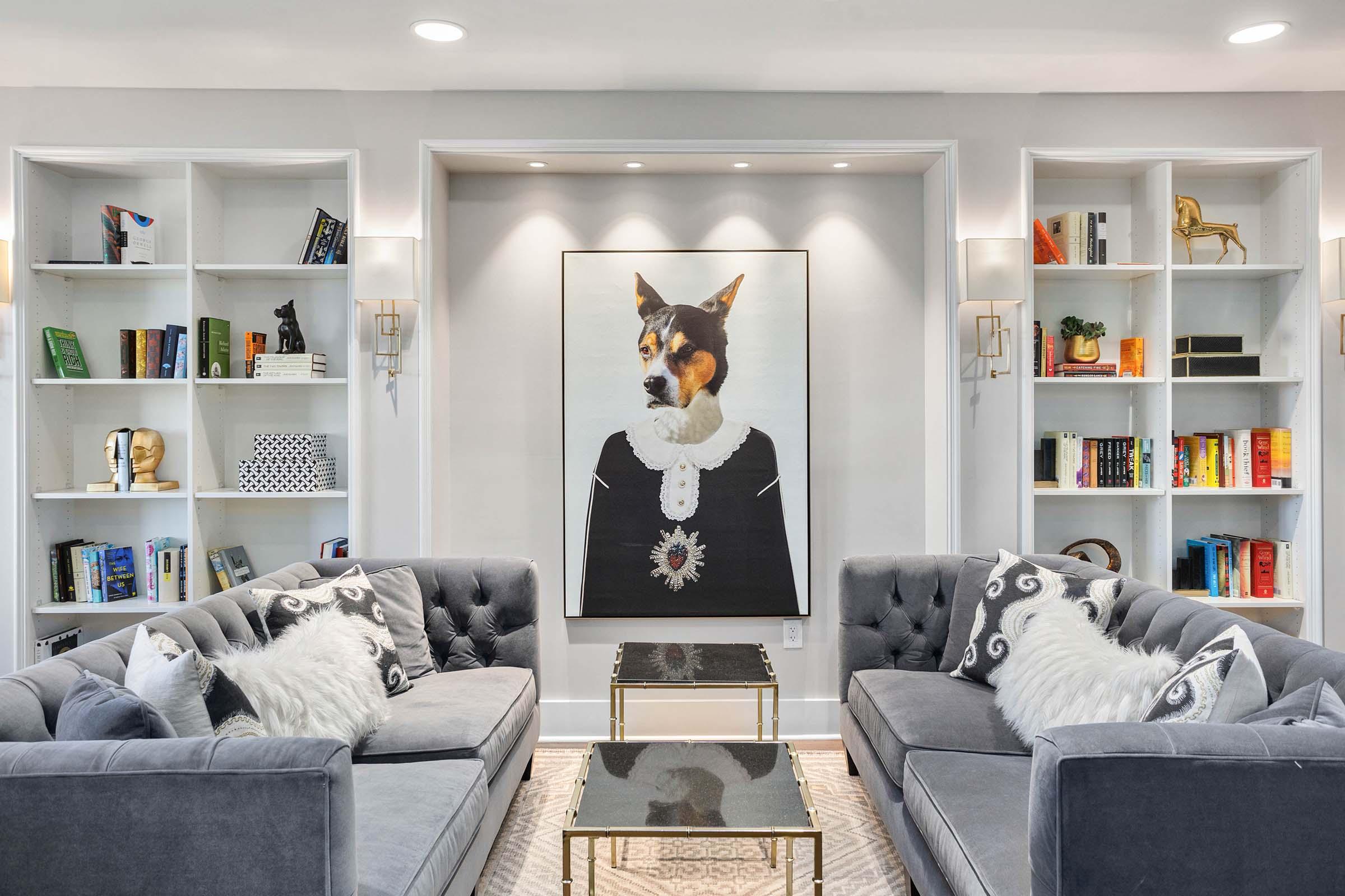 a living room filled with furniture and pictures on the wall