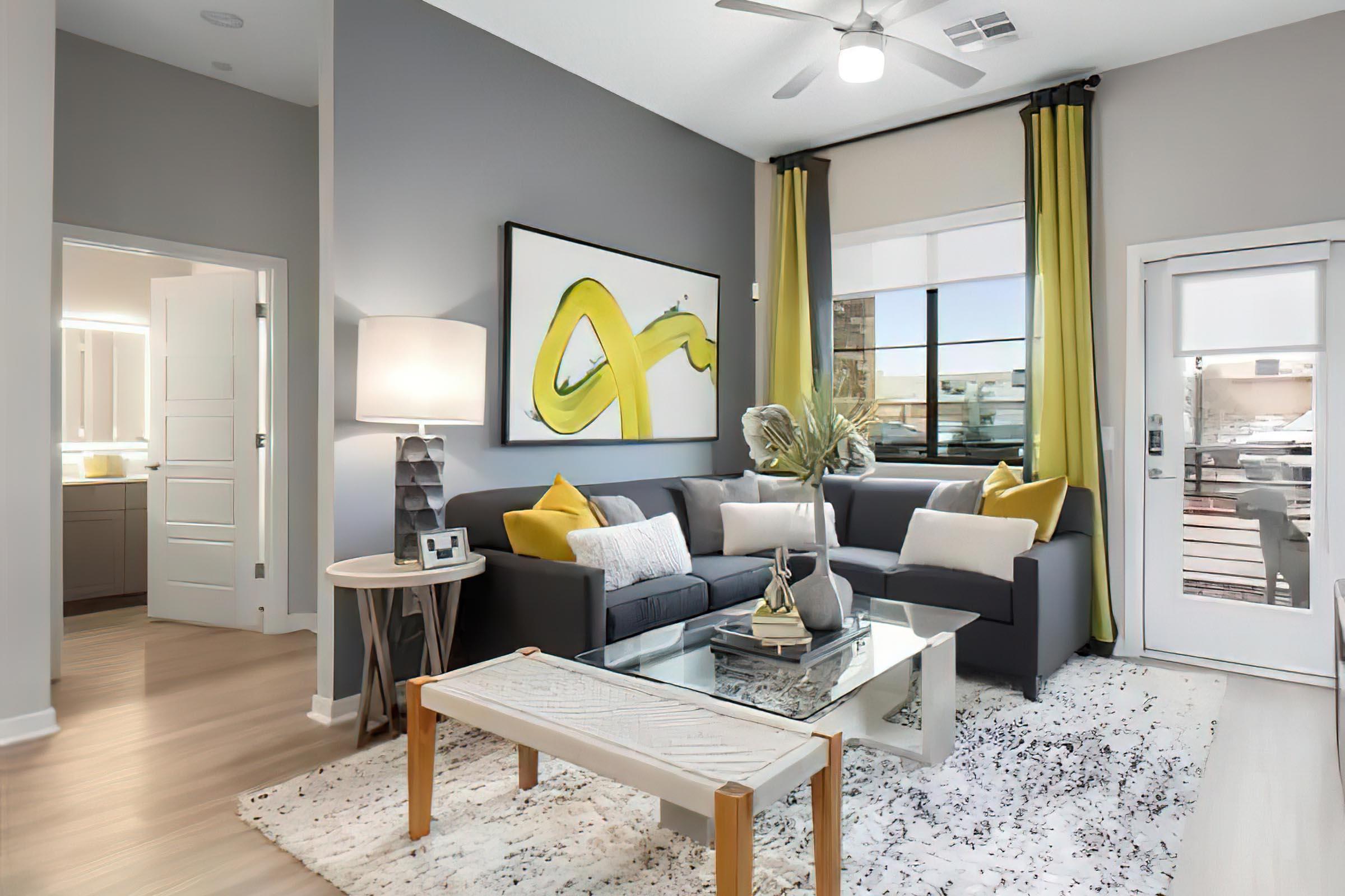 a living room filled with furniture and a large window