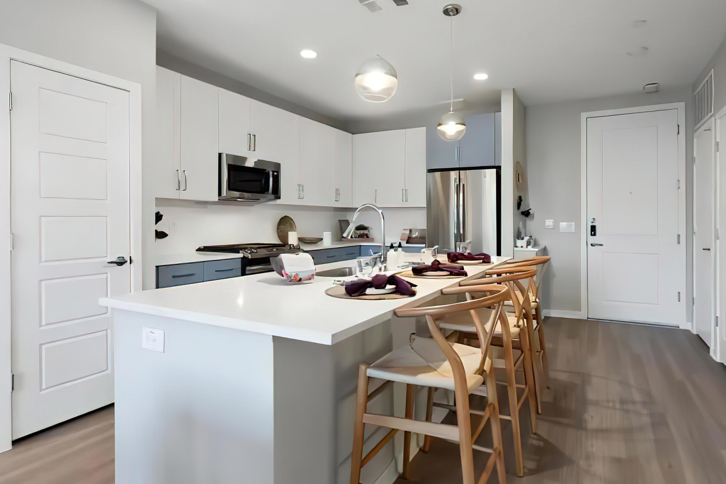 a kitchen with an island in the middle of a room