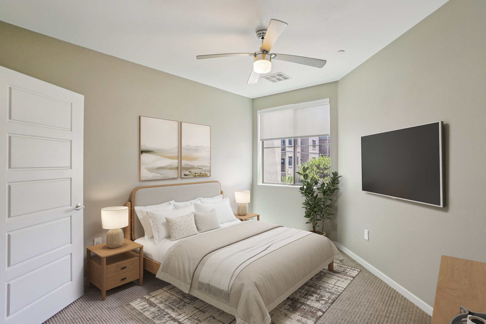 A cozy bedroom featuring a large bed with white and beige bedding, two bedside tables with lamps, a potted plant, a wall-mounted TV, and large windows allowing natural light. Soft, neutral-colored walls and a patterned rug create a warm, inviting atmosphere.