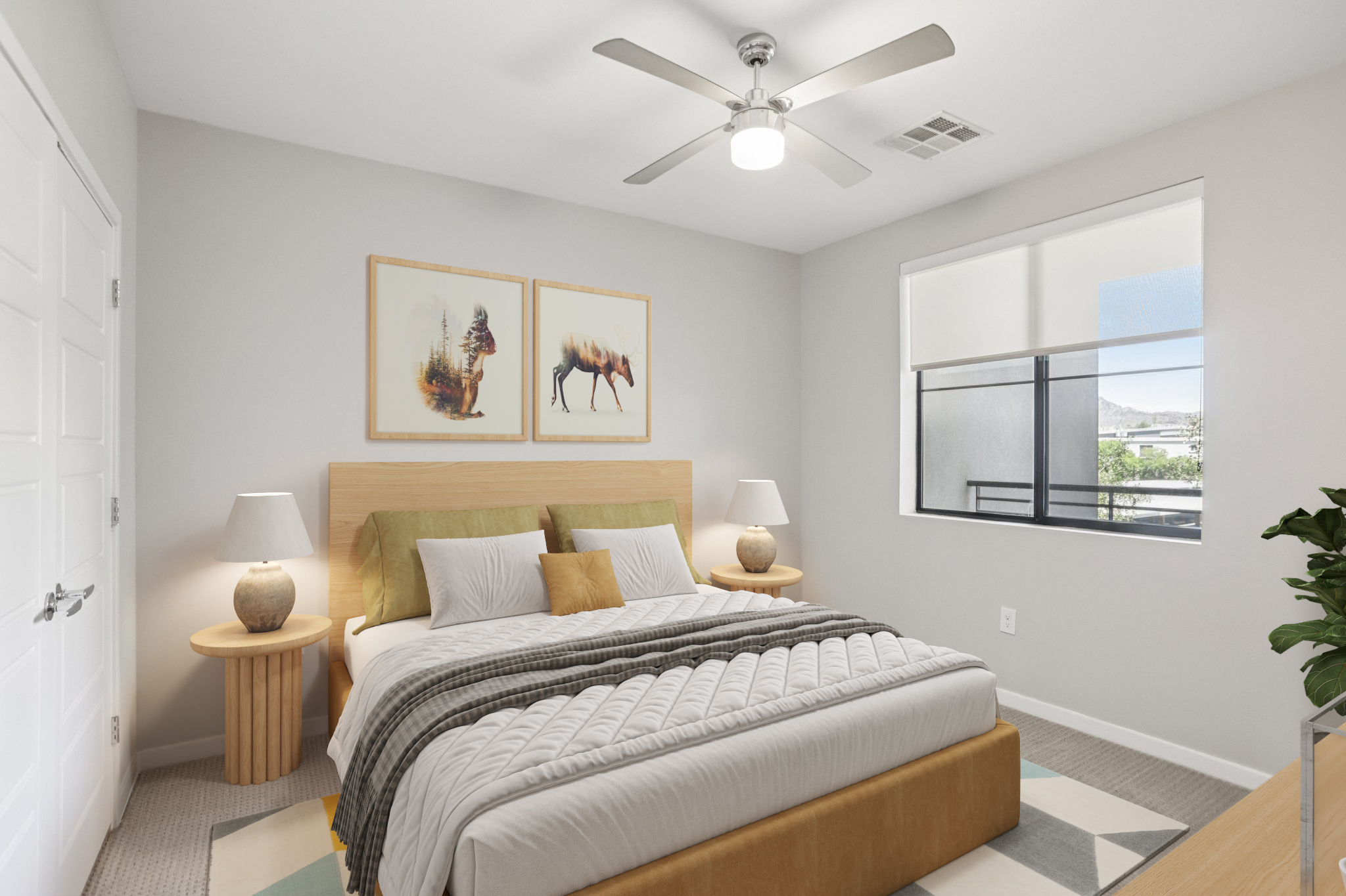 A modern bedroom featuring a large bed with a neutral-colored comforter, two side tables with lamps, and framed artwork on the walls. A window allows natural light to enter, and a potted plant adds a touch of greenery. The decor is minimalist and inviting, with a soft gray color palette.