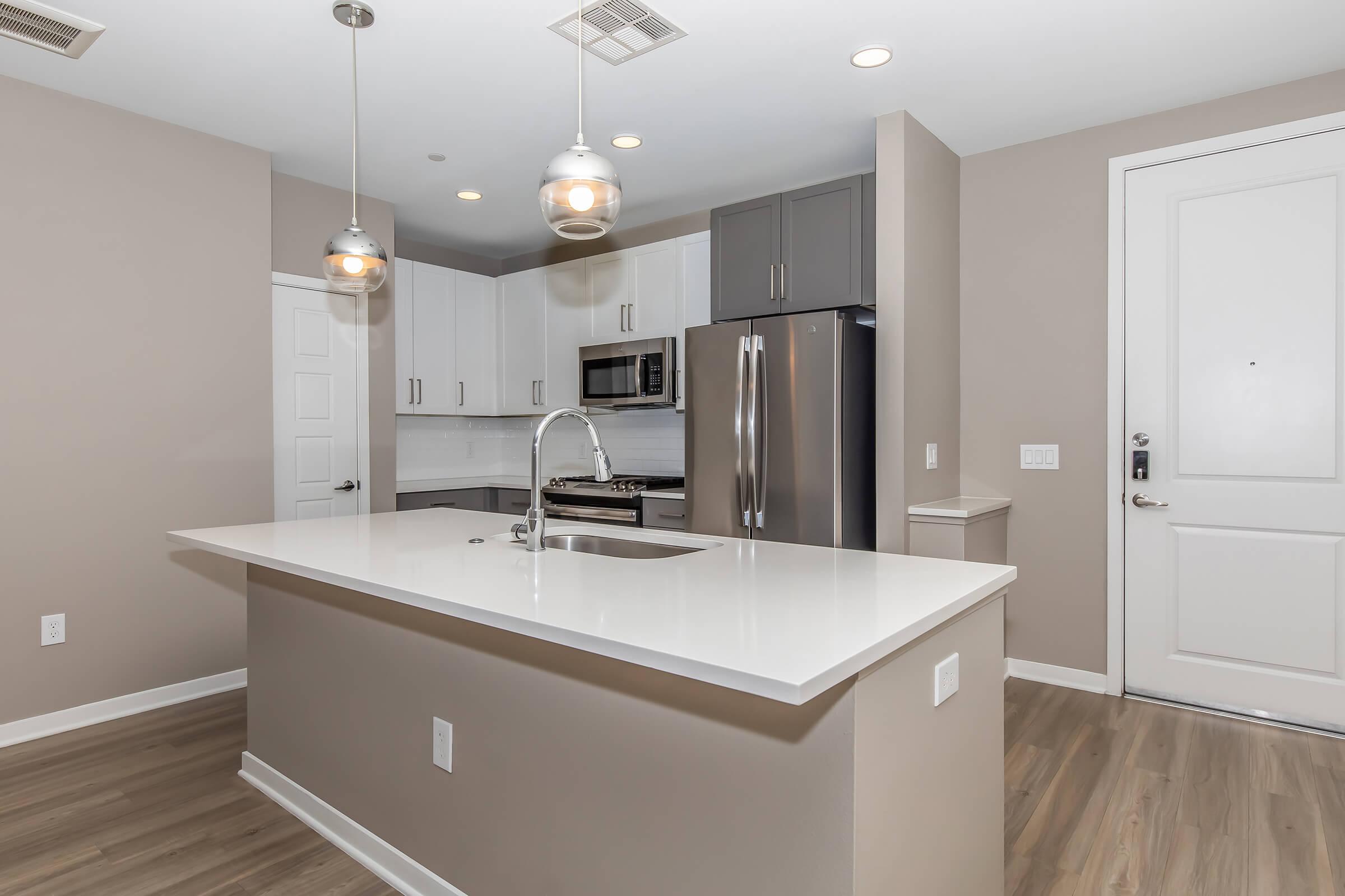 a kitchen with a sink and a mirror