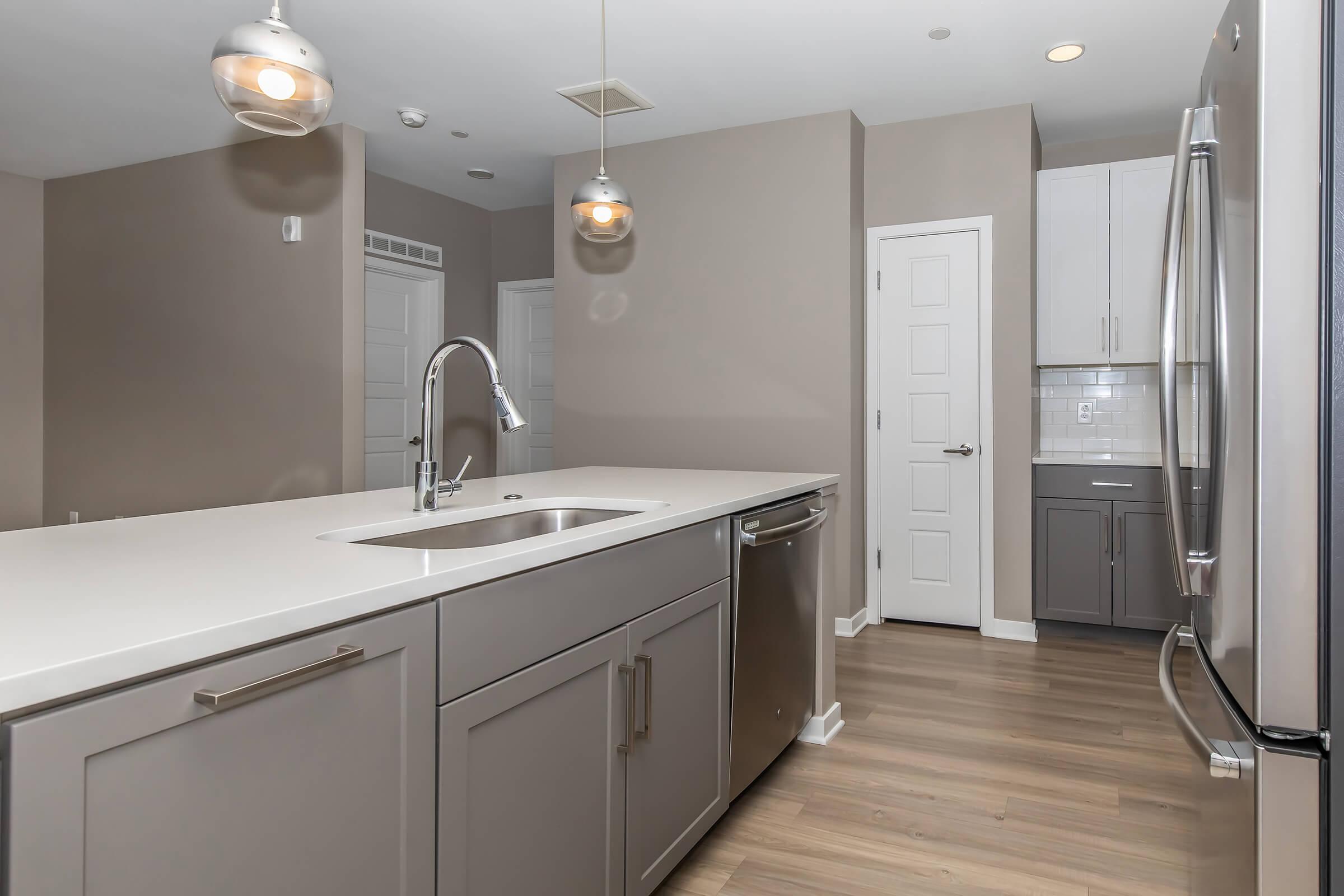 a kitchen with a sink and a mirror