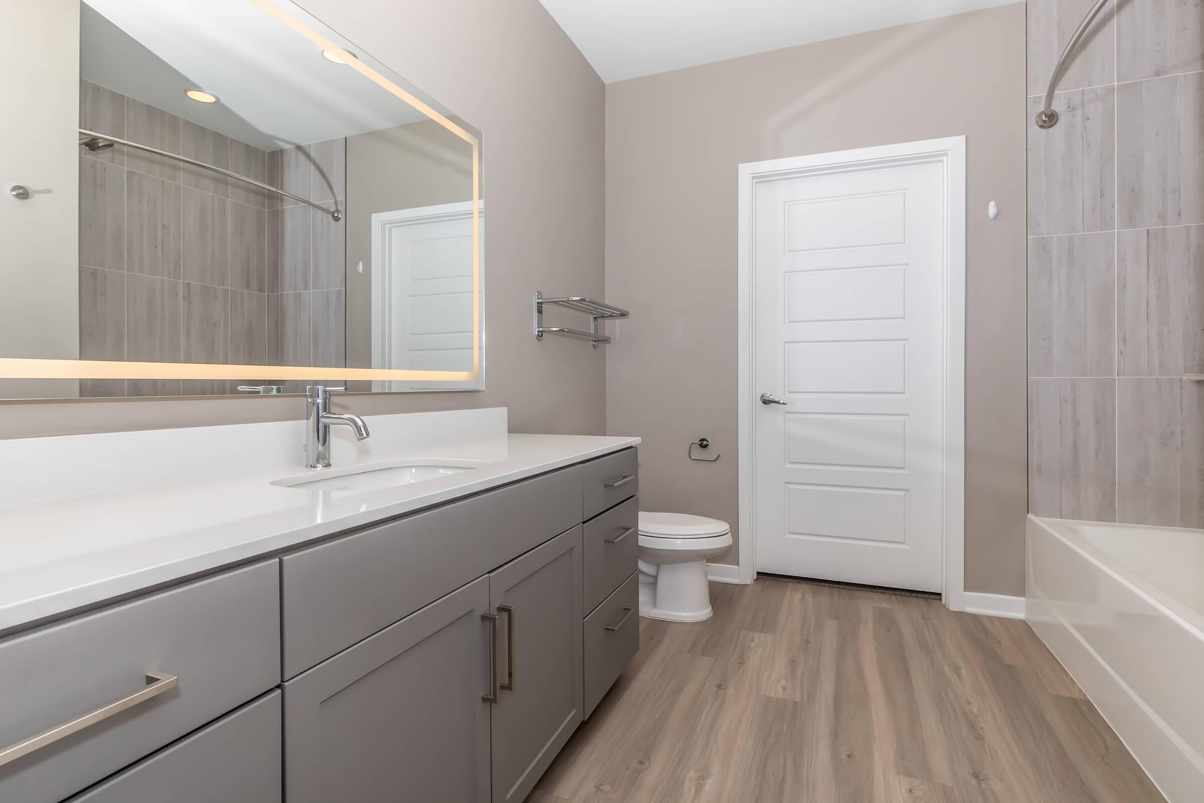 a kitchen with a sink and a mirror