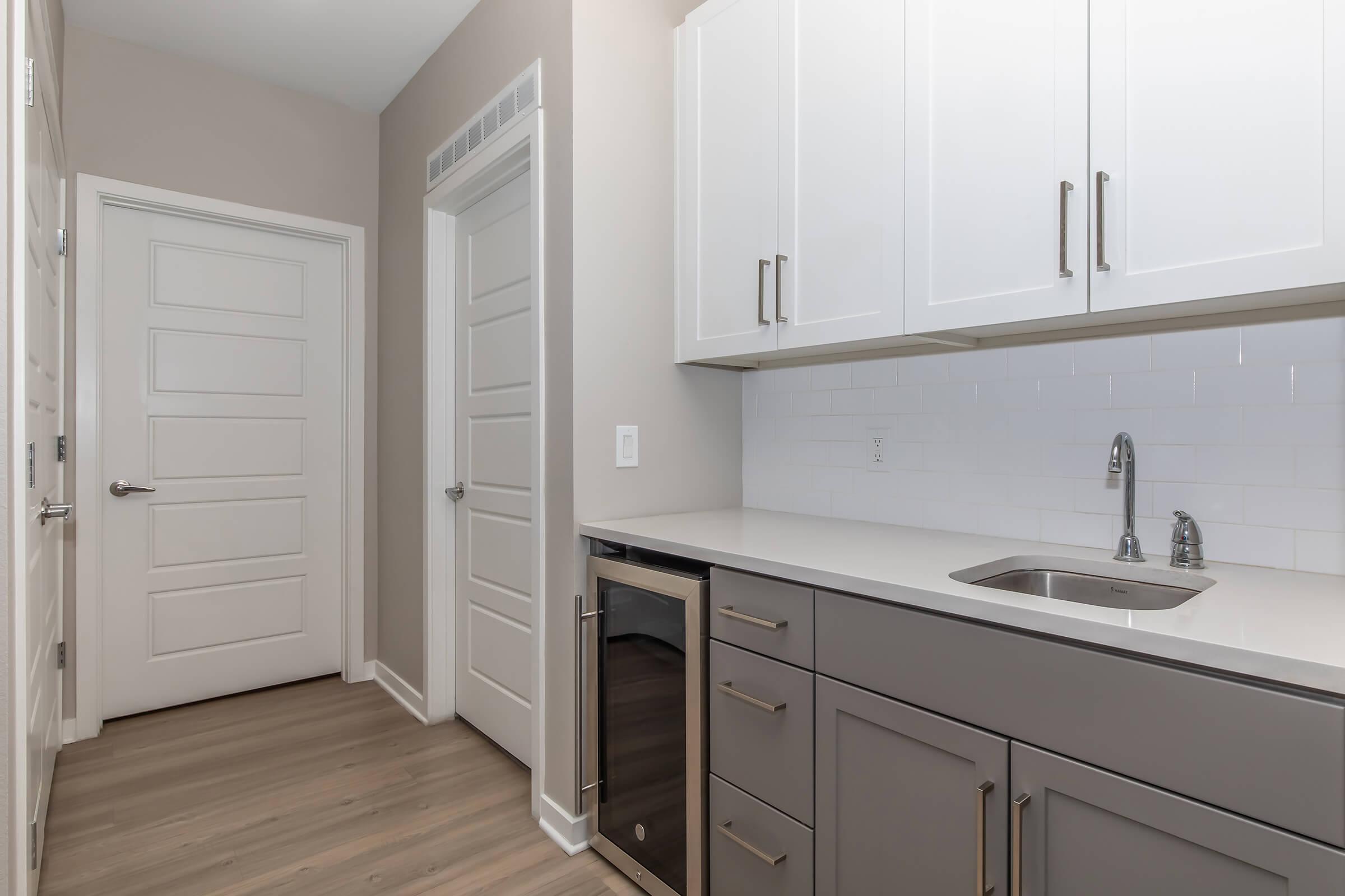 a kitchen with a sink and a refrigerator