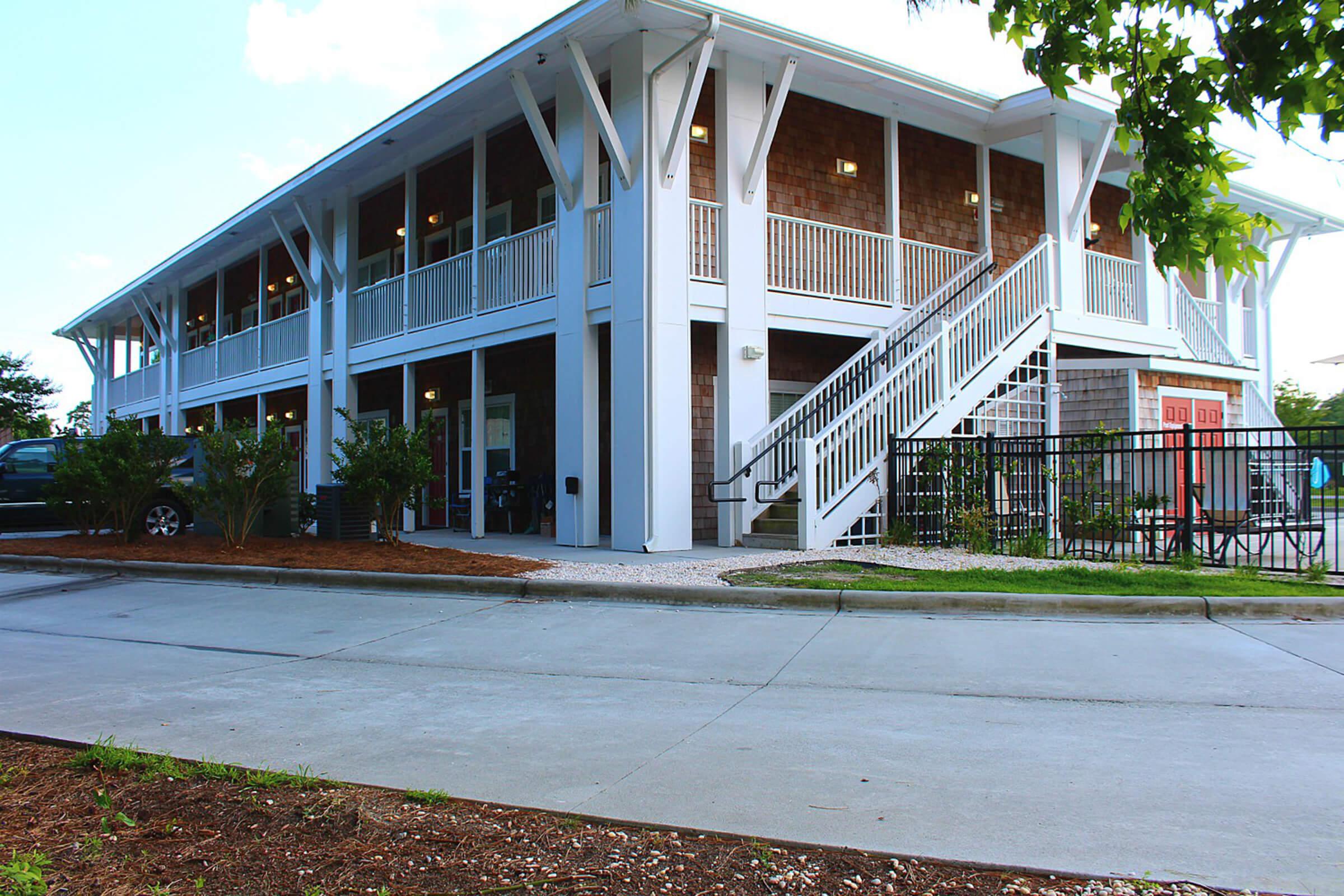 a house with a lawn in front of a building