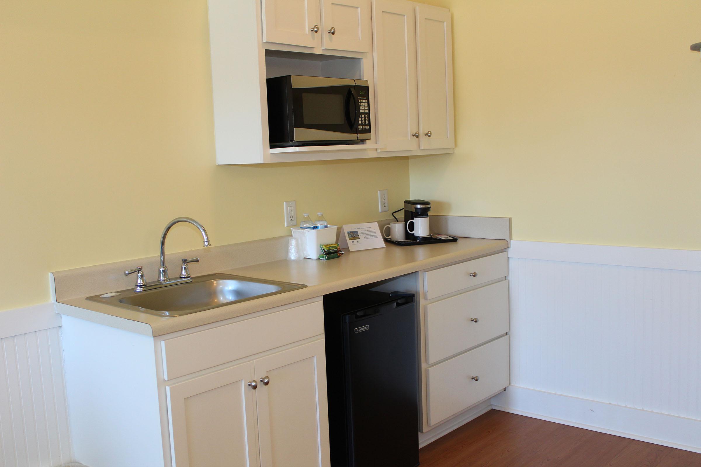 a kitchen with a sink and a mirror