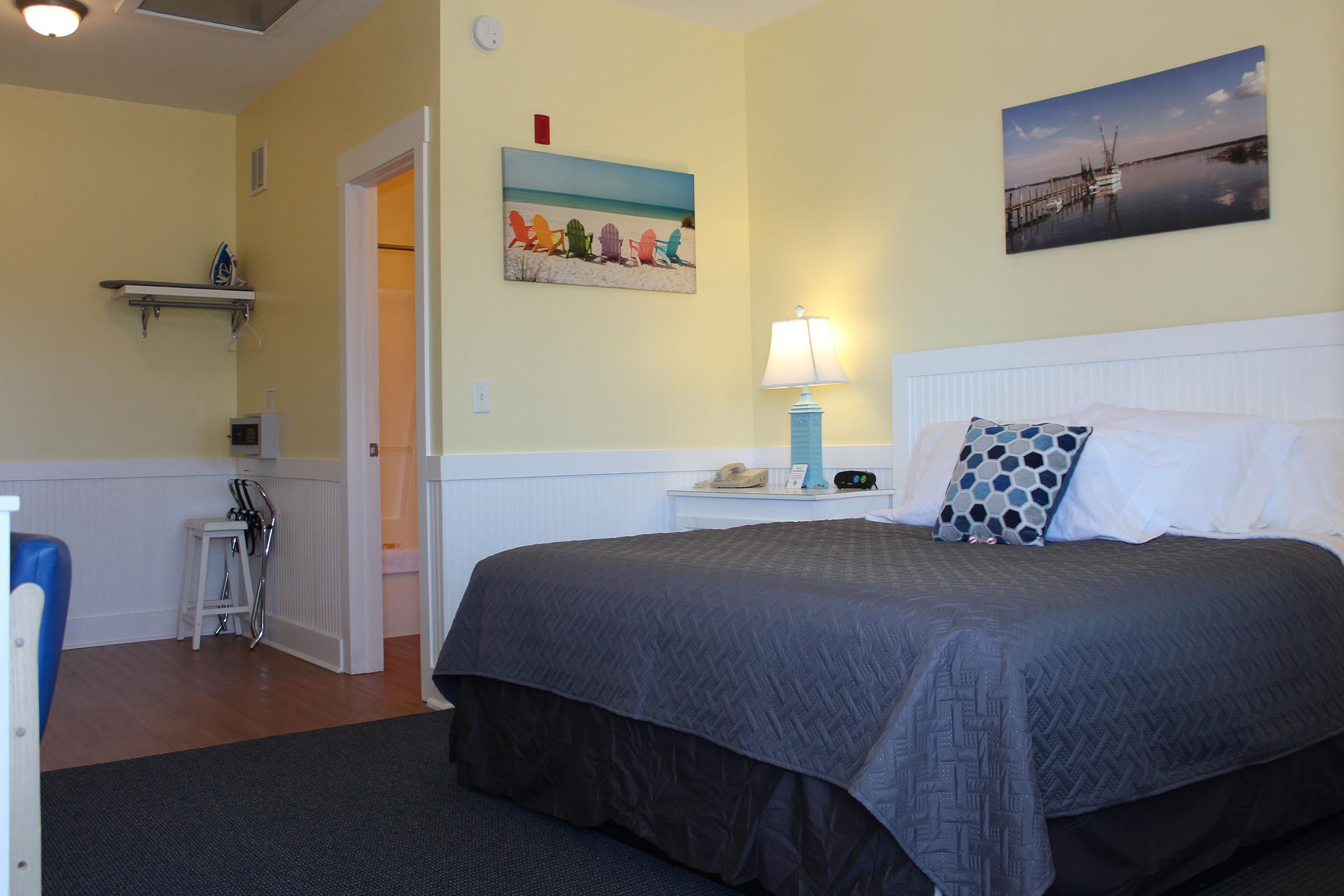 a bedroom with a bed and desk in a room