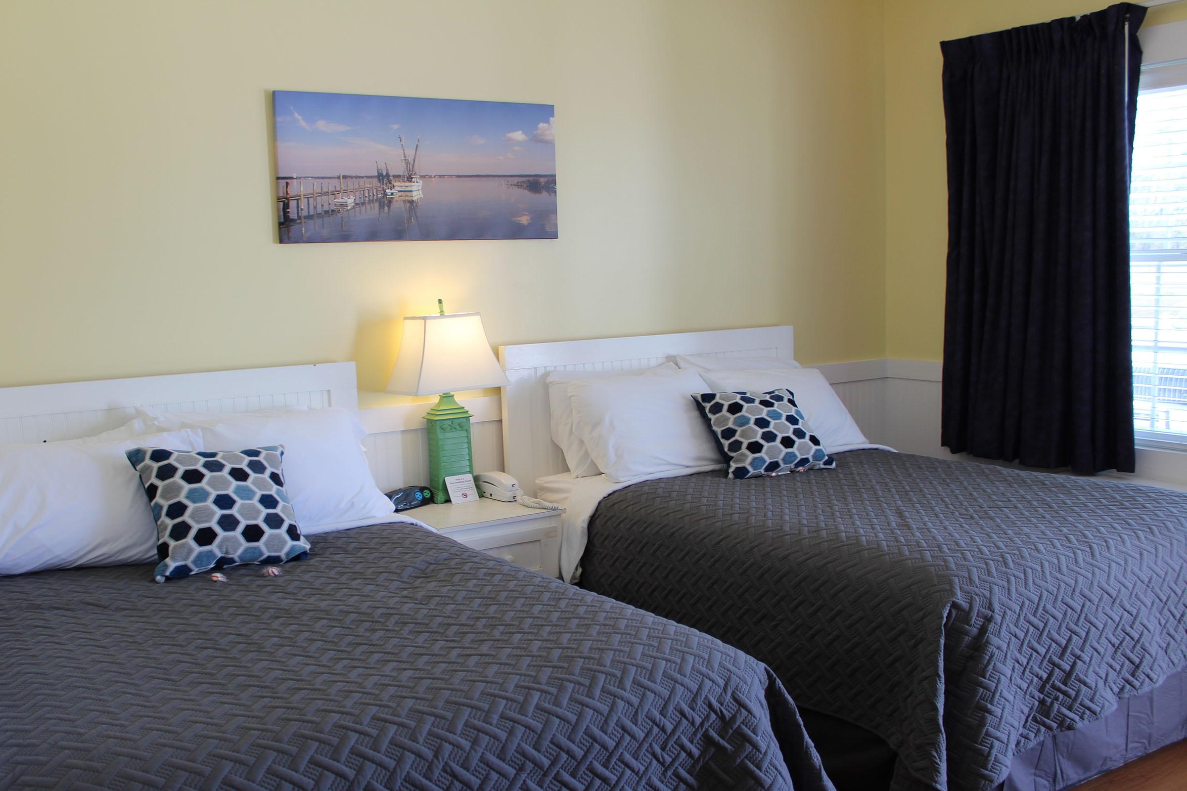 a bedroom with a made up bed in a hotel room