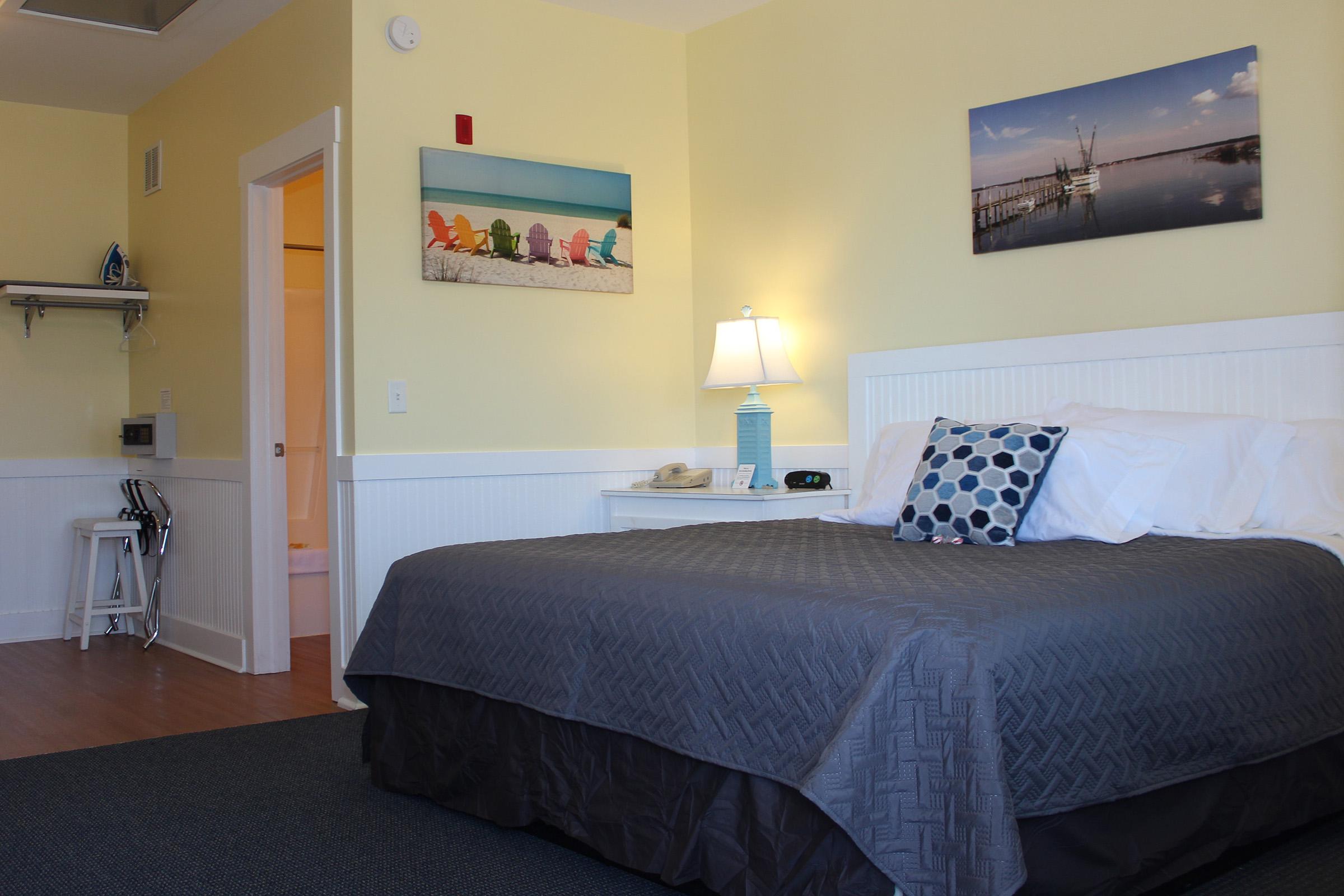 a bedroom with a bed and desk in a room