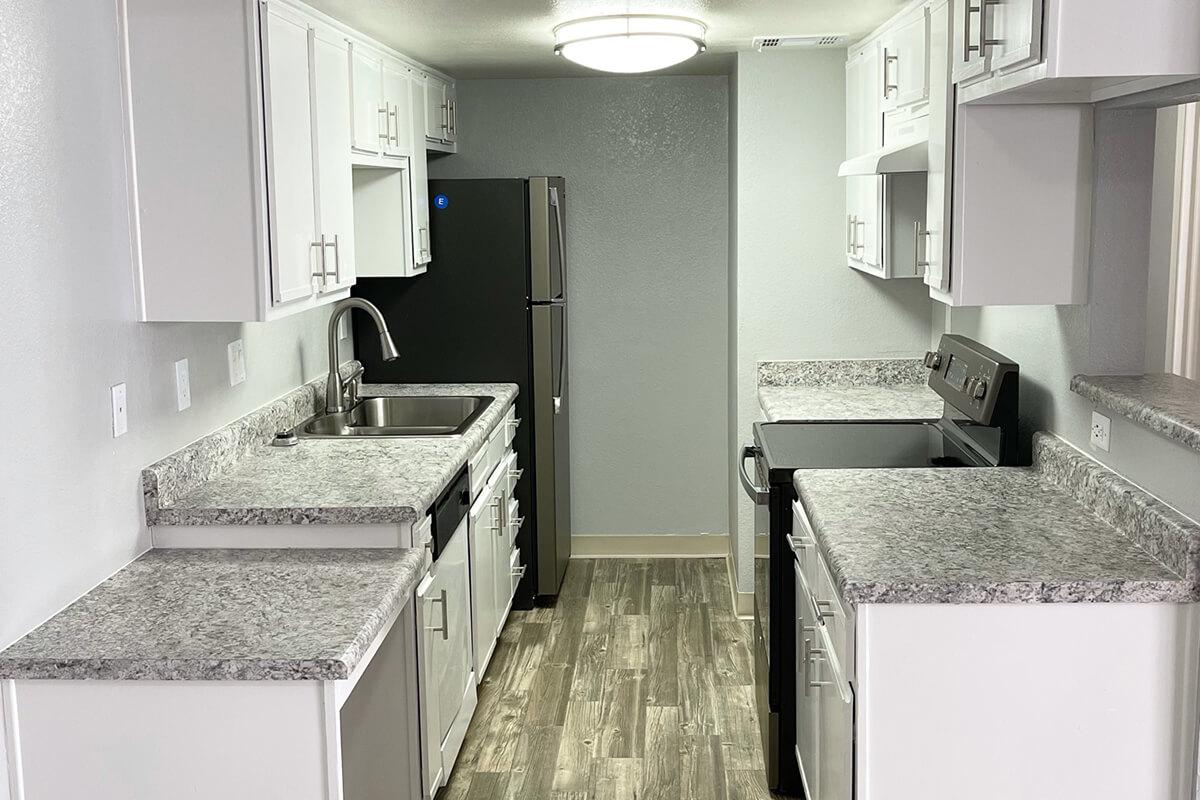 a kitchen with a sink and a mirror