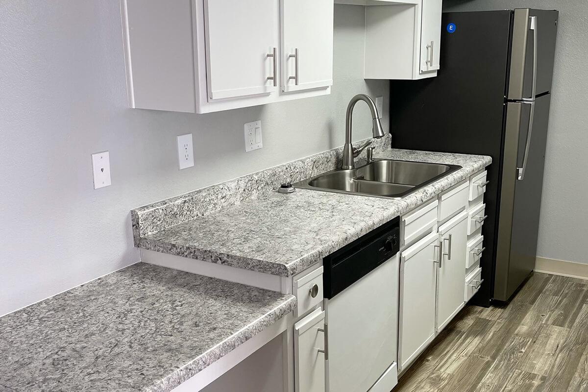a kitchen with a sink and a mirror