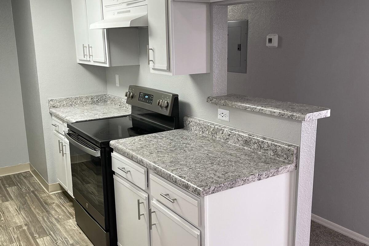 a kitchen with a sink and a mirror