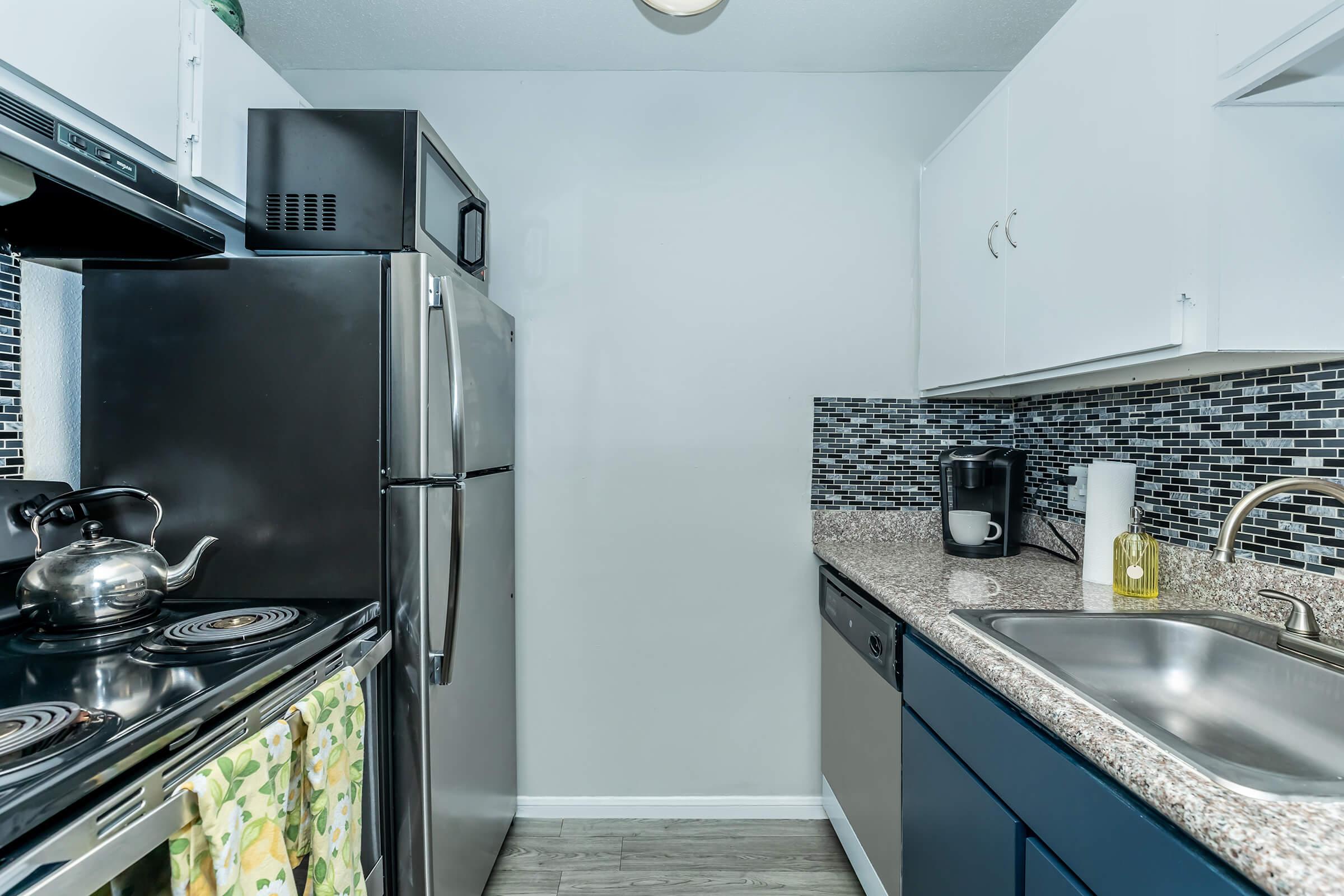 a stove top oven sitting inside of a kitchen