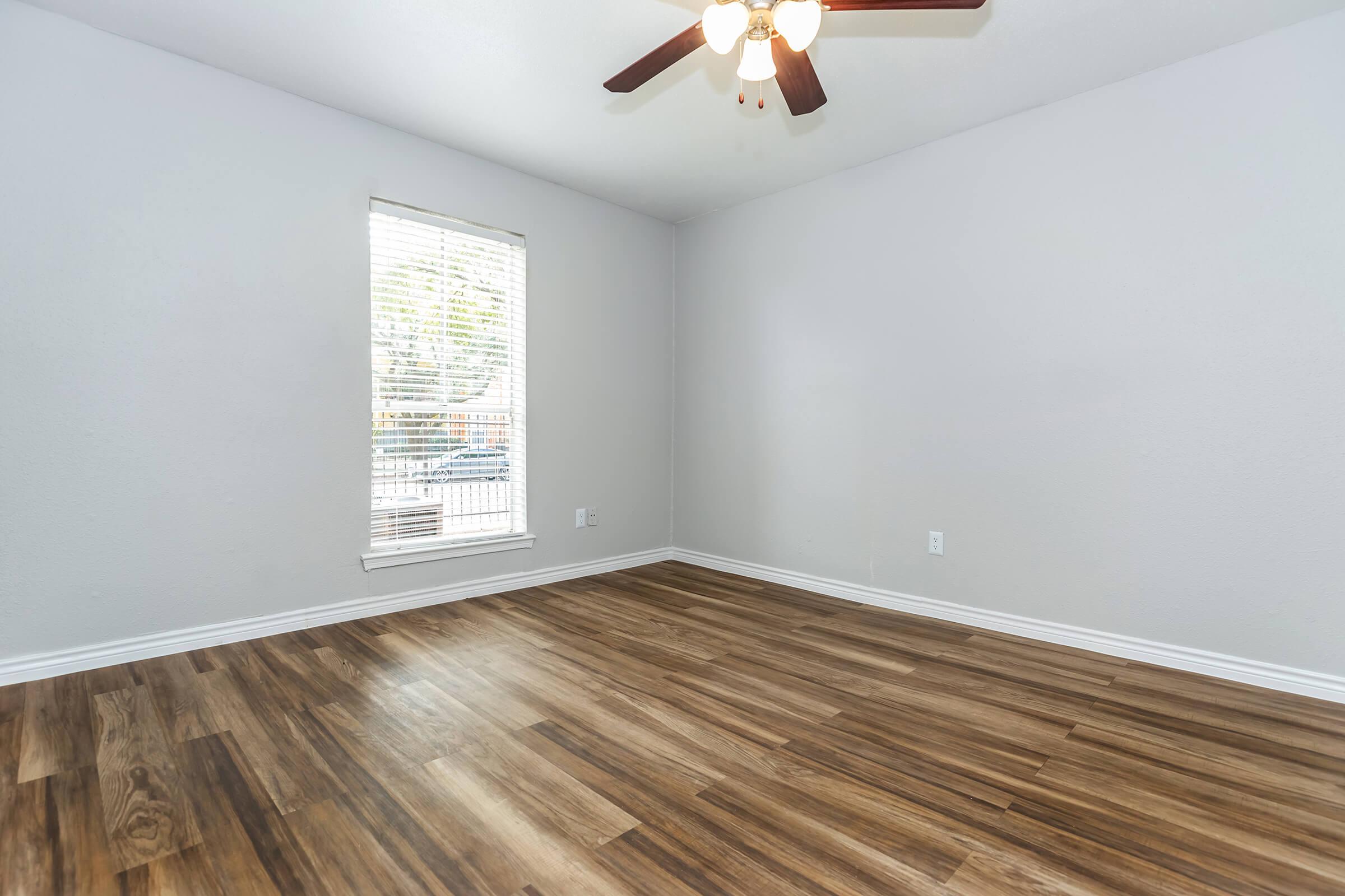 a large empty room with a wooden floor