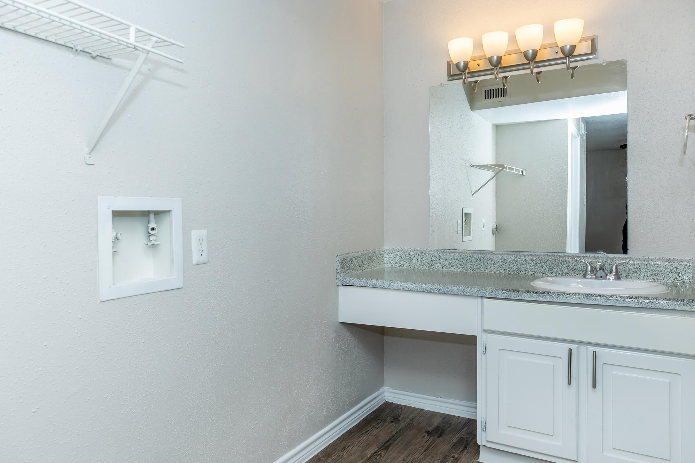 a kitchen with a sink and a mirror