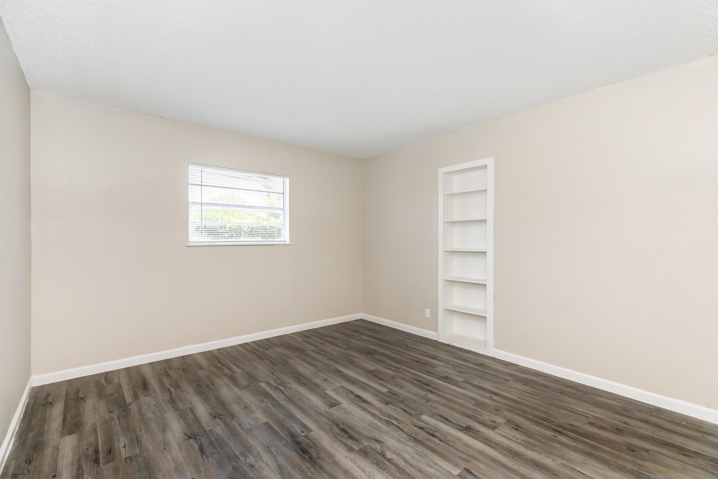 a bedroom with a wooden floor