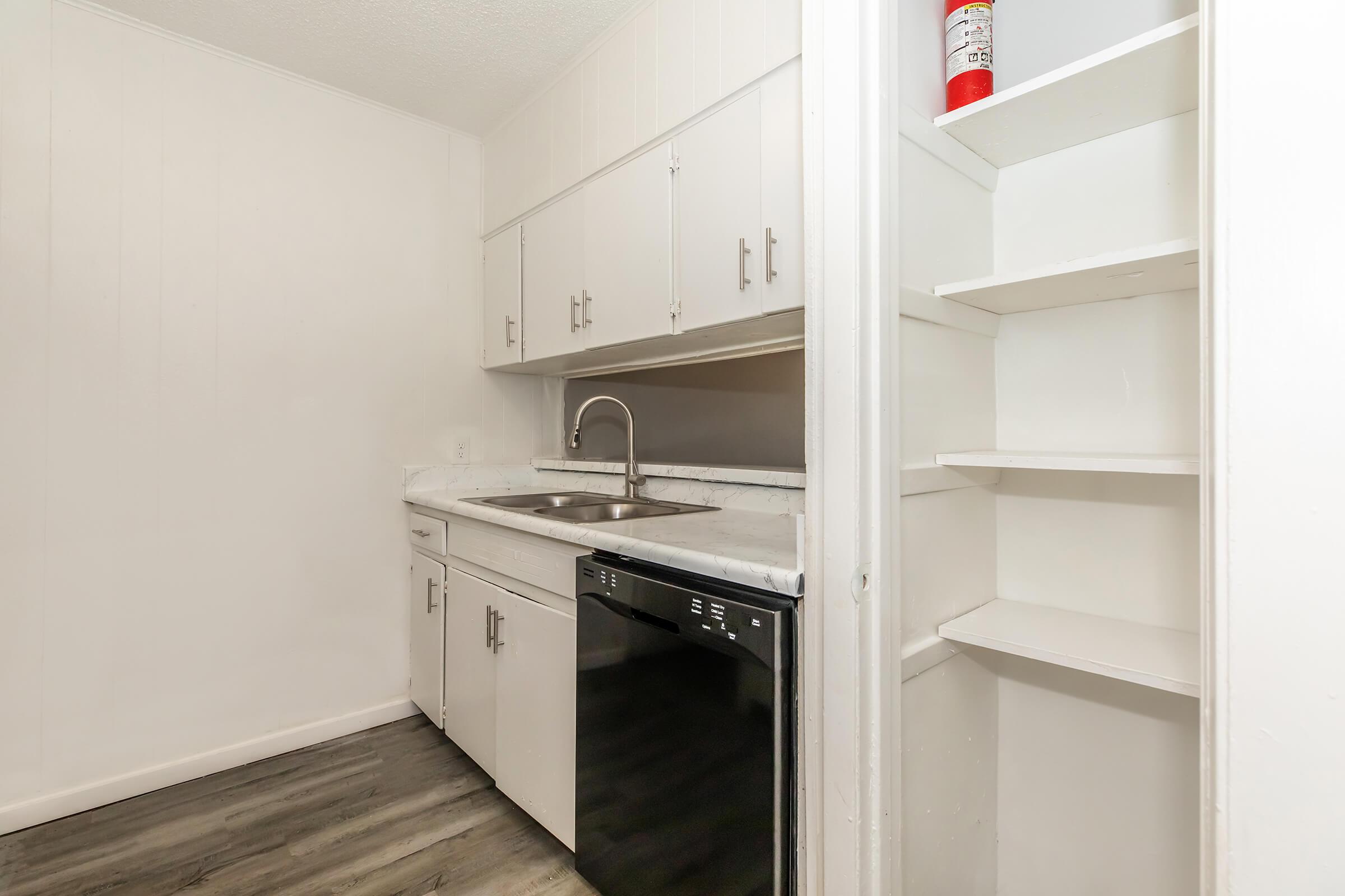 a kitchen with a sink and a refrigerator