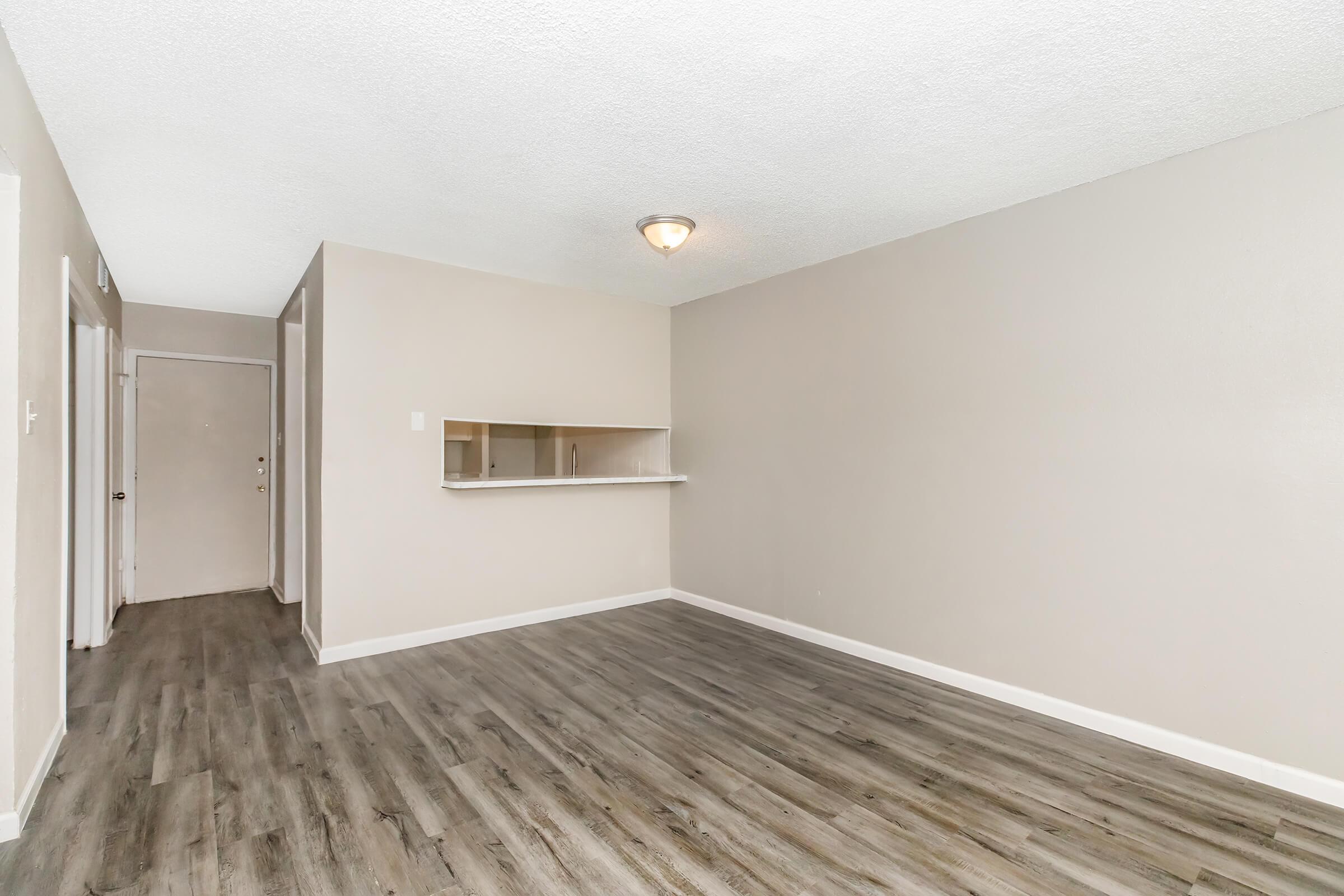 a large empty room with a wooden floor