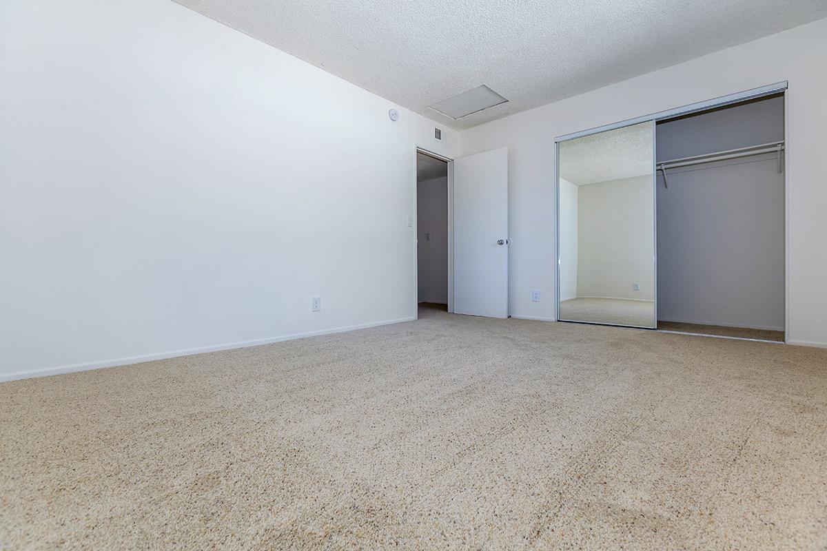 Bedroom with sliding mirror glass closet door