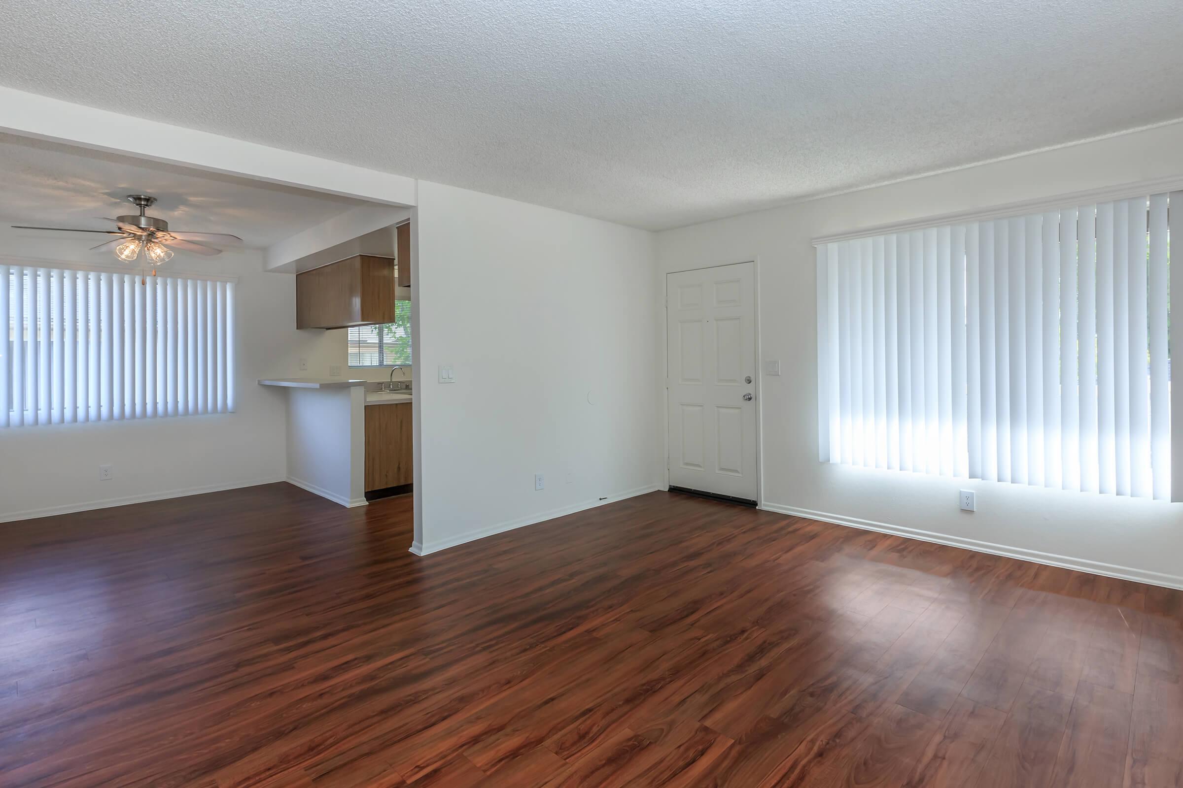 Unfurnished living room and dining room with wooden floor