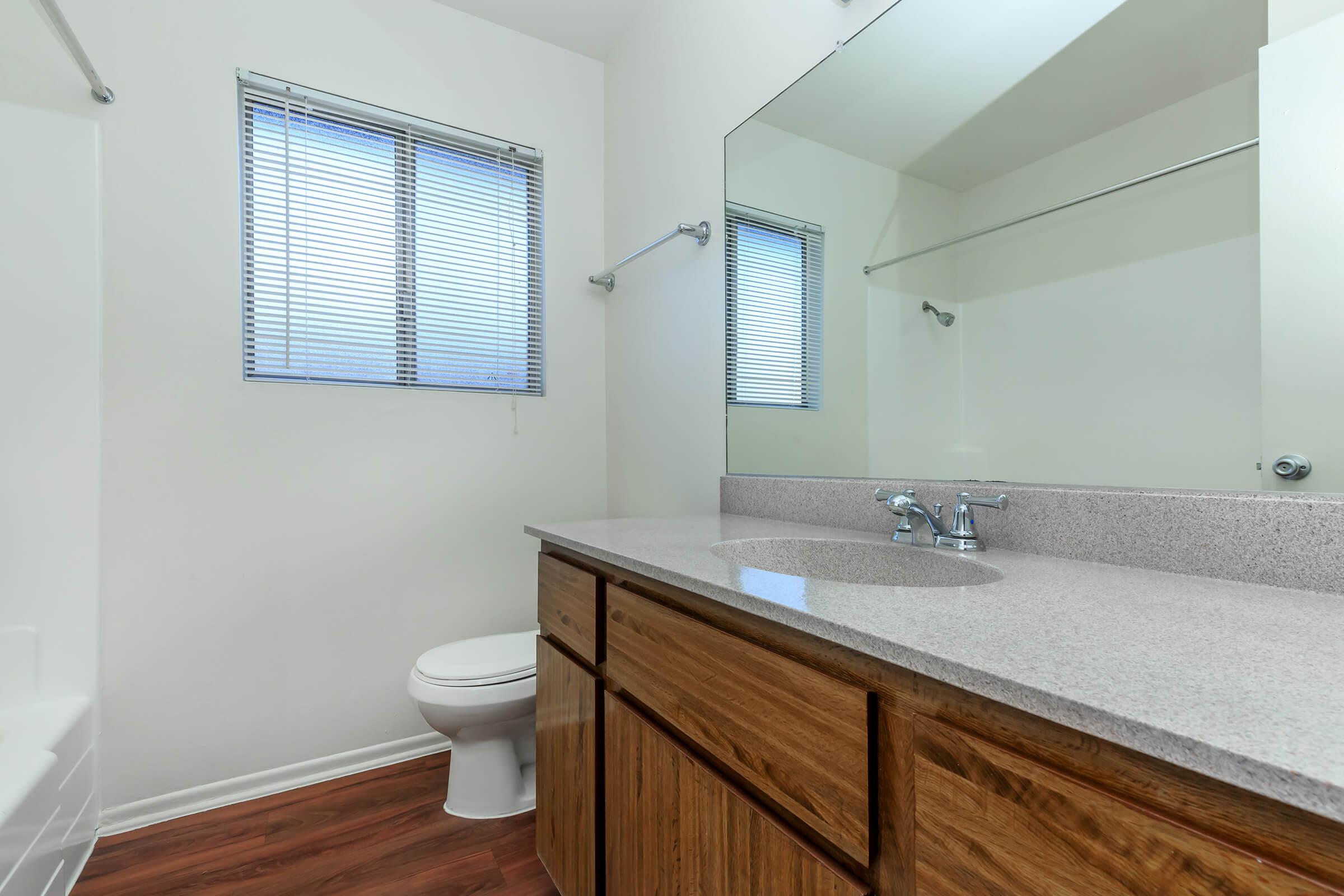 Vacant bathroom with wooden floors