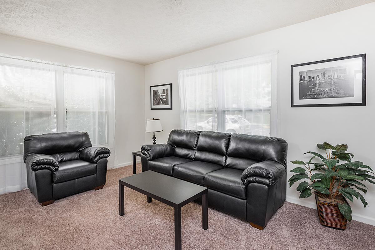 a living room filled with furniture and a flat screen tv