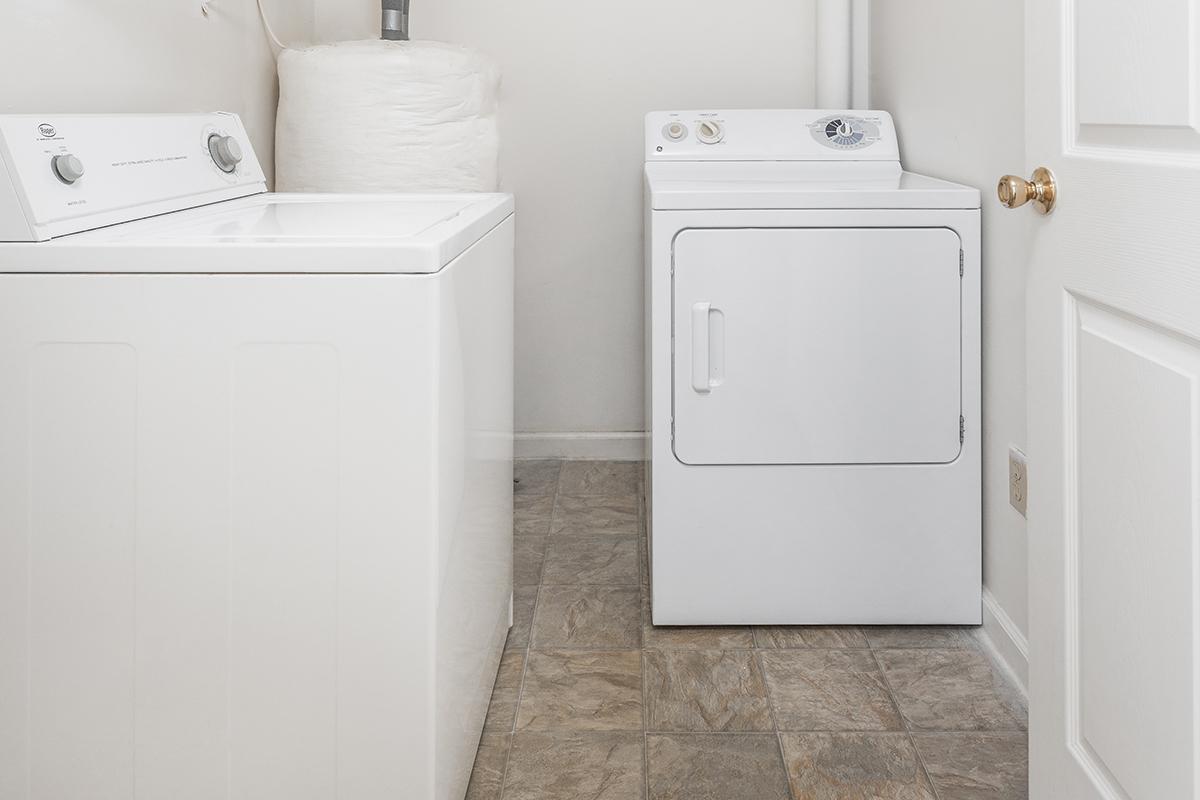 a white microwave oven sitting on top of a refrigerator