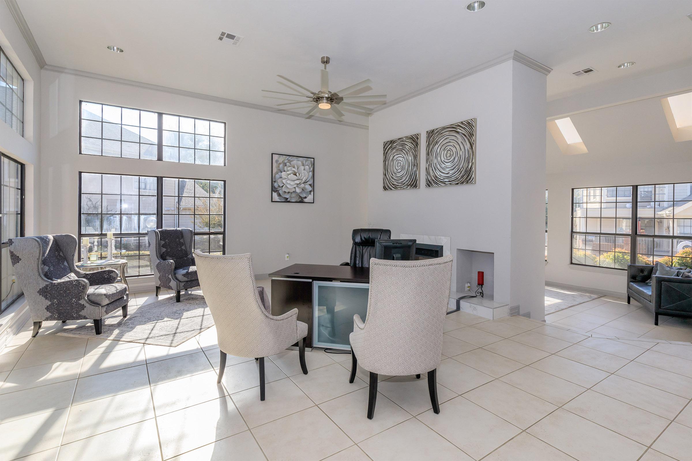 a living room filled with furniture and a large window