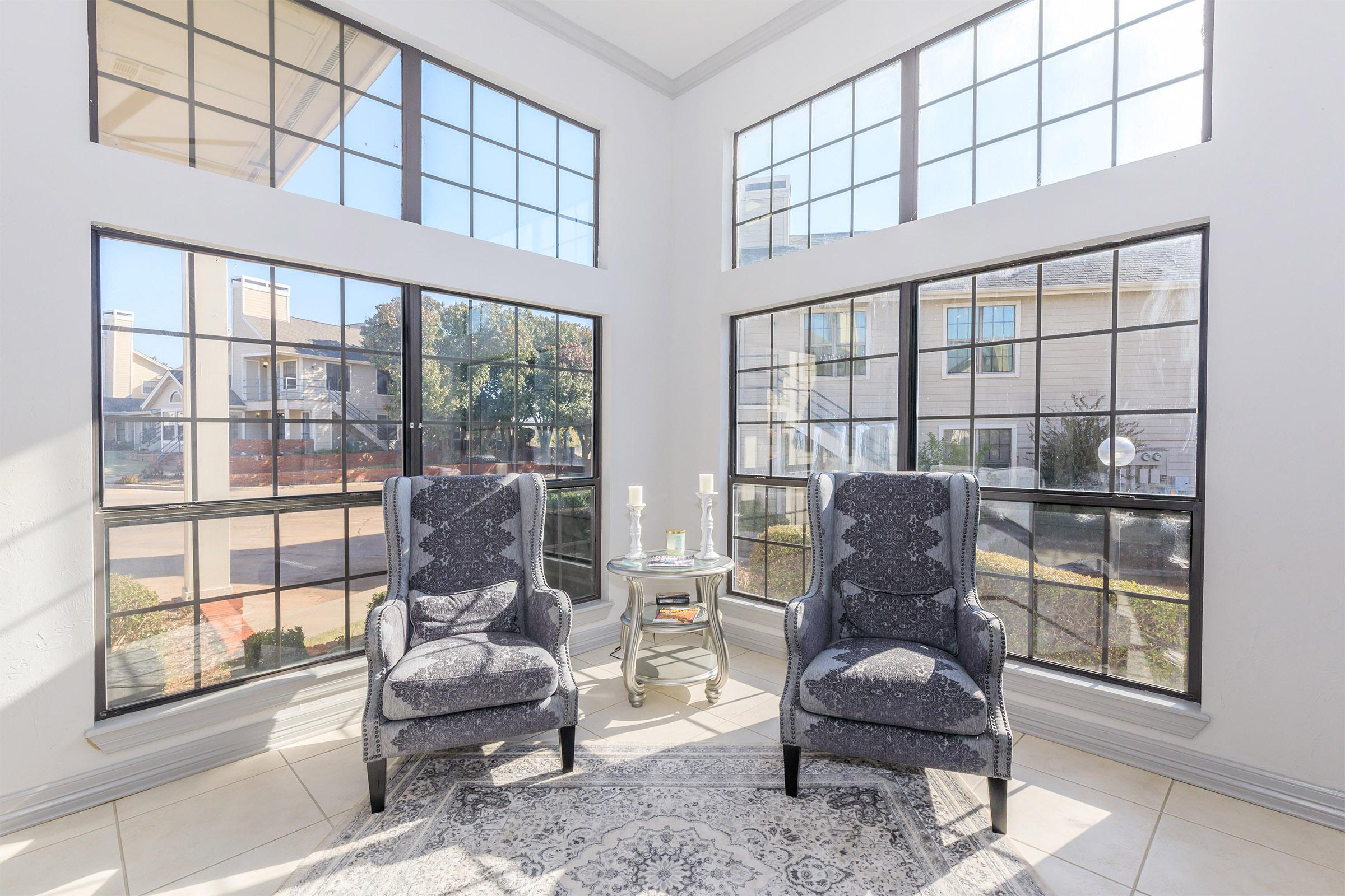 a living room filled with furniture and a large window