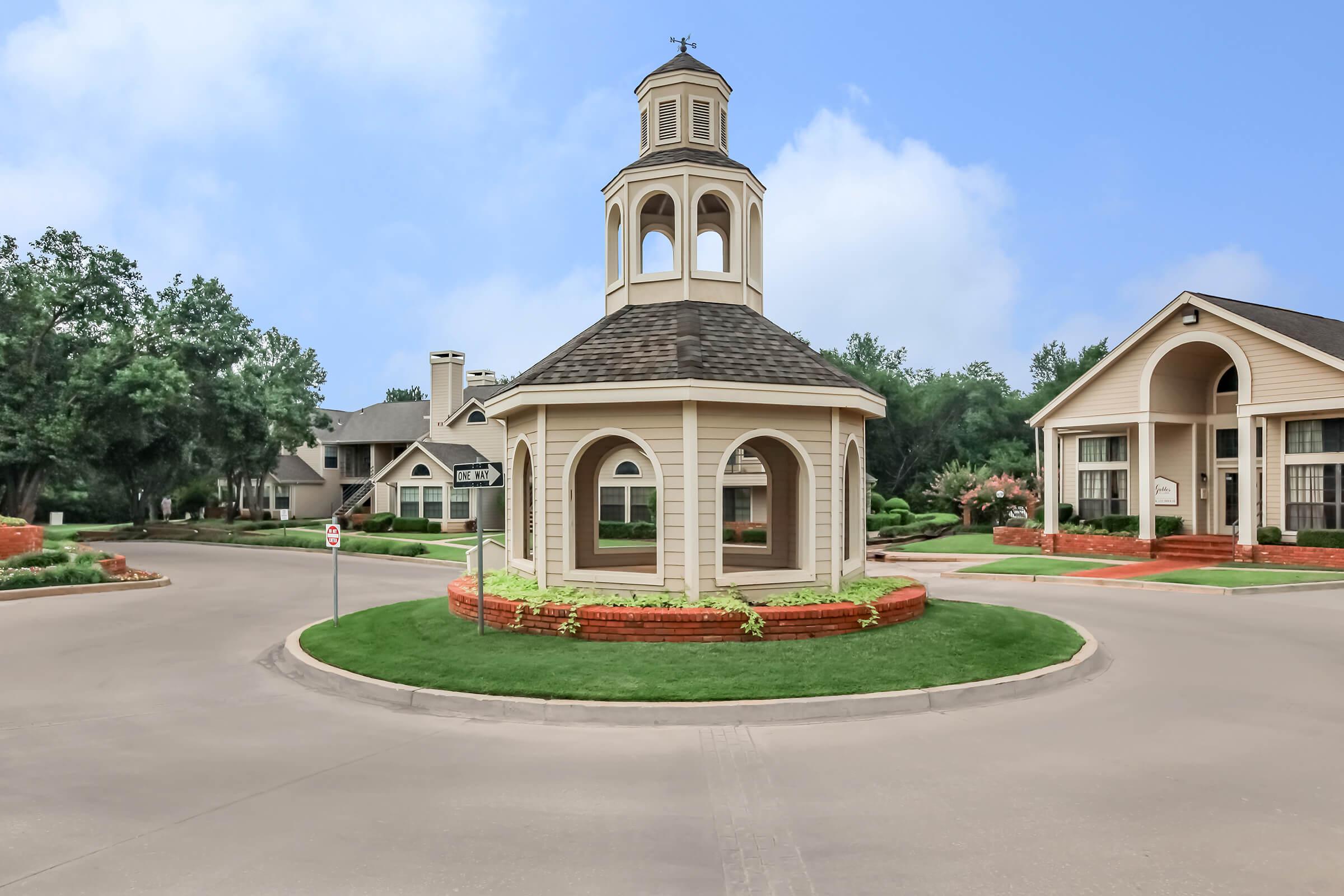 a small clock tower in front of a house