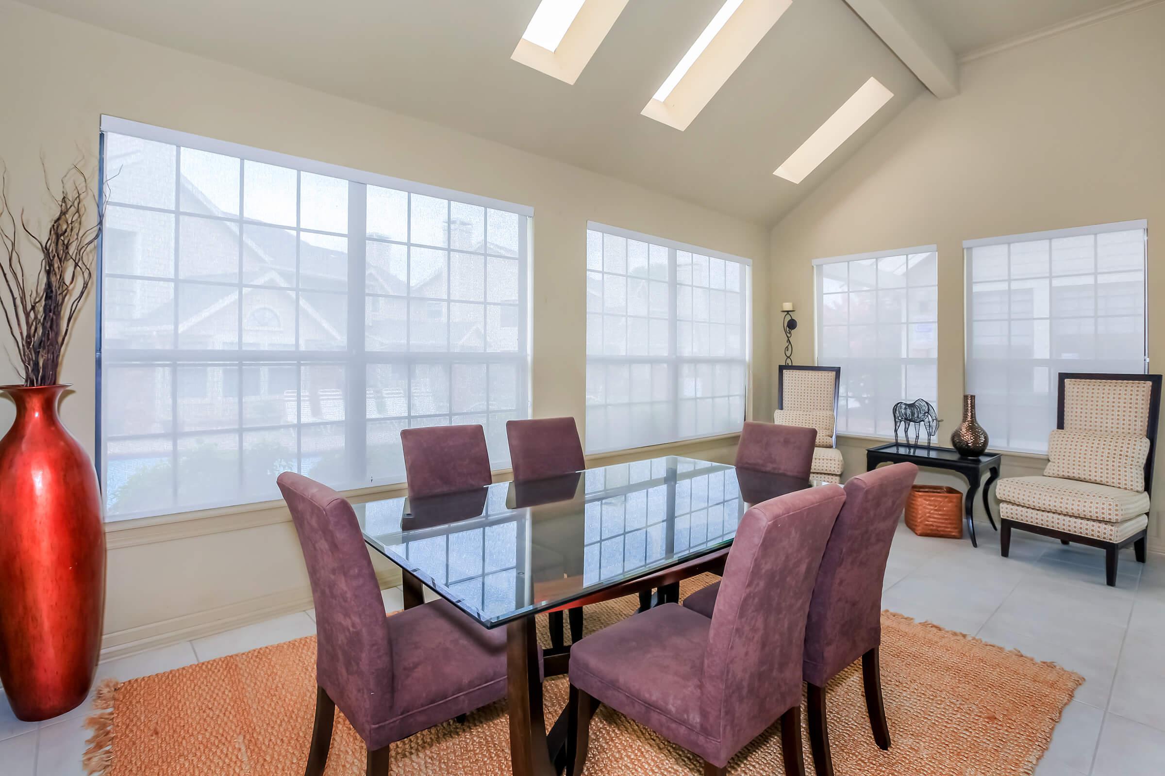 a living room filled with furniture and a large window