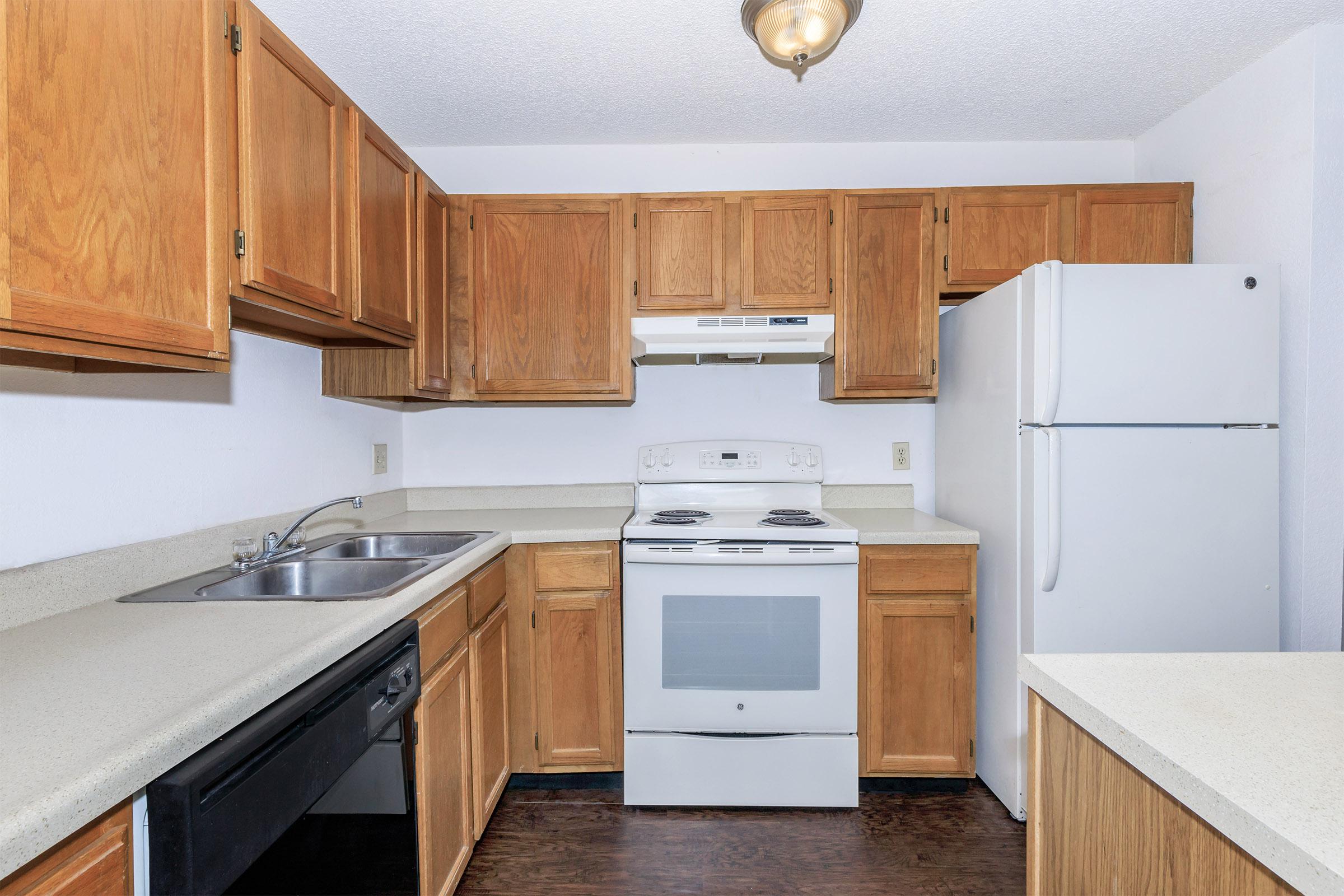 a kitchen with wooden cabinets and an oven