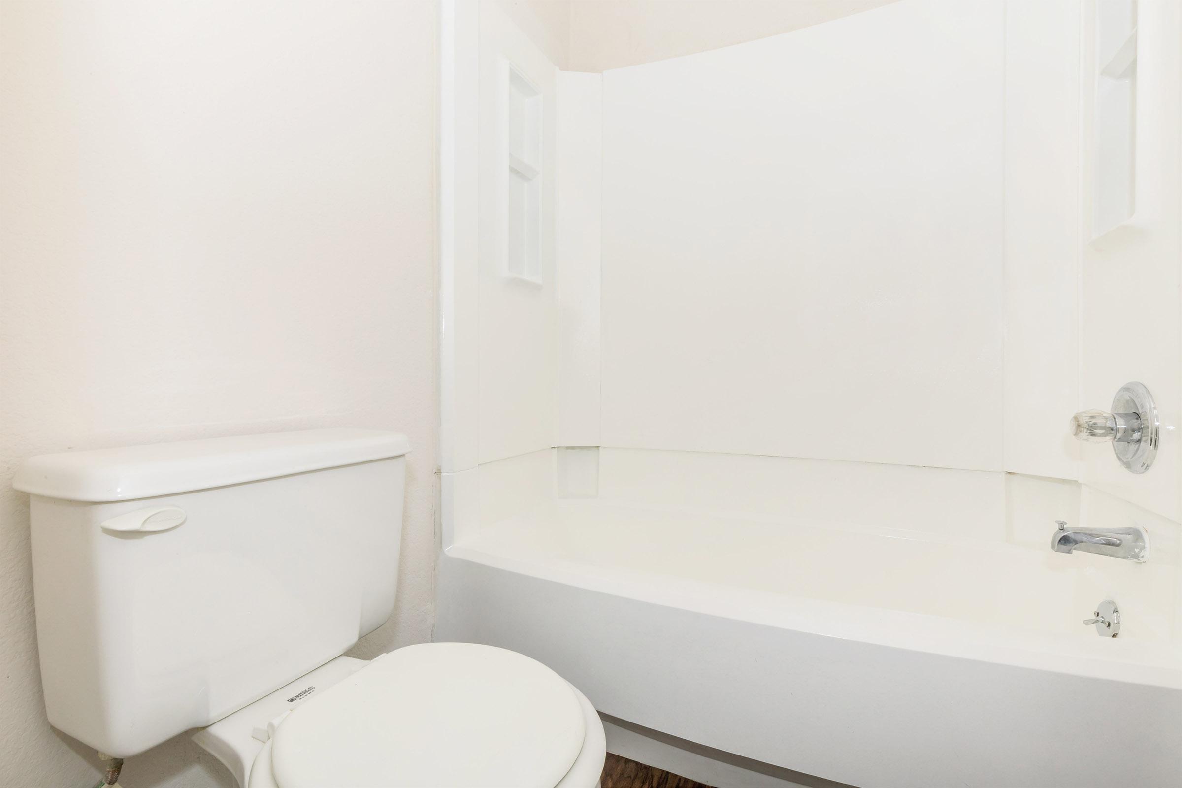 a white tub sitting next to a sink